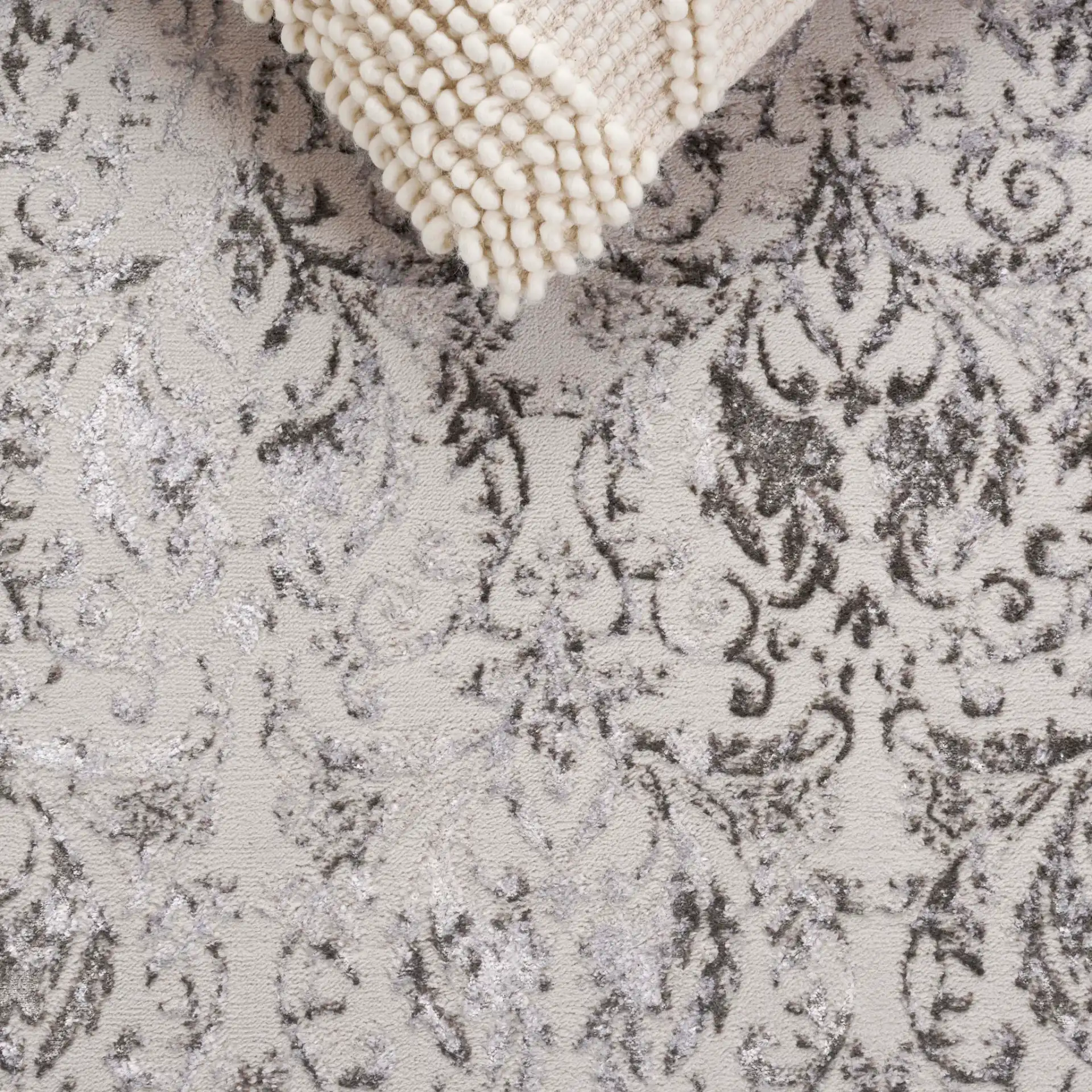 Orchard Distressed Damask Rug in Gray / Silver in a styled room