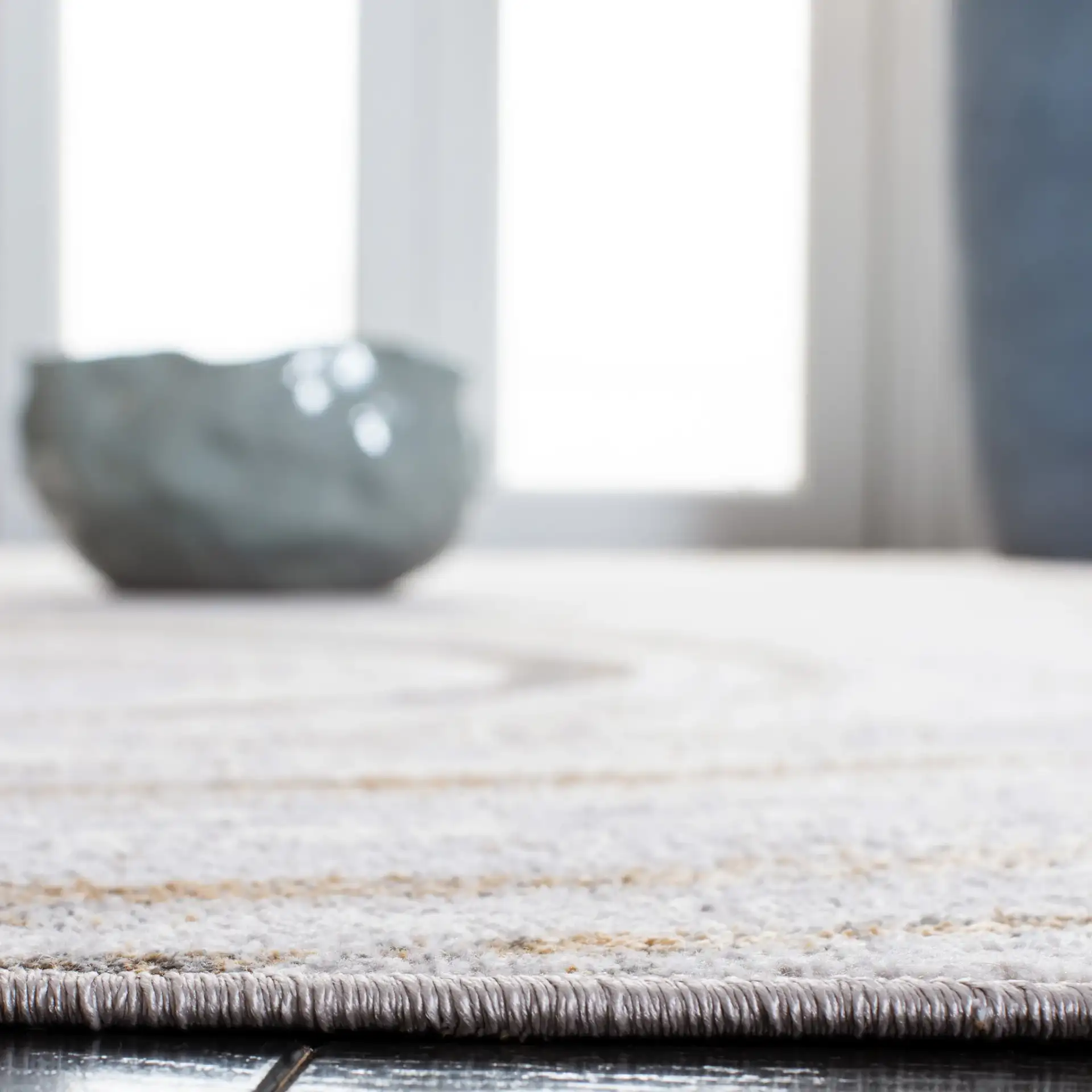Orchard Swirl Abstract Rug in Gray / Gold in a styled room