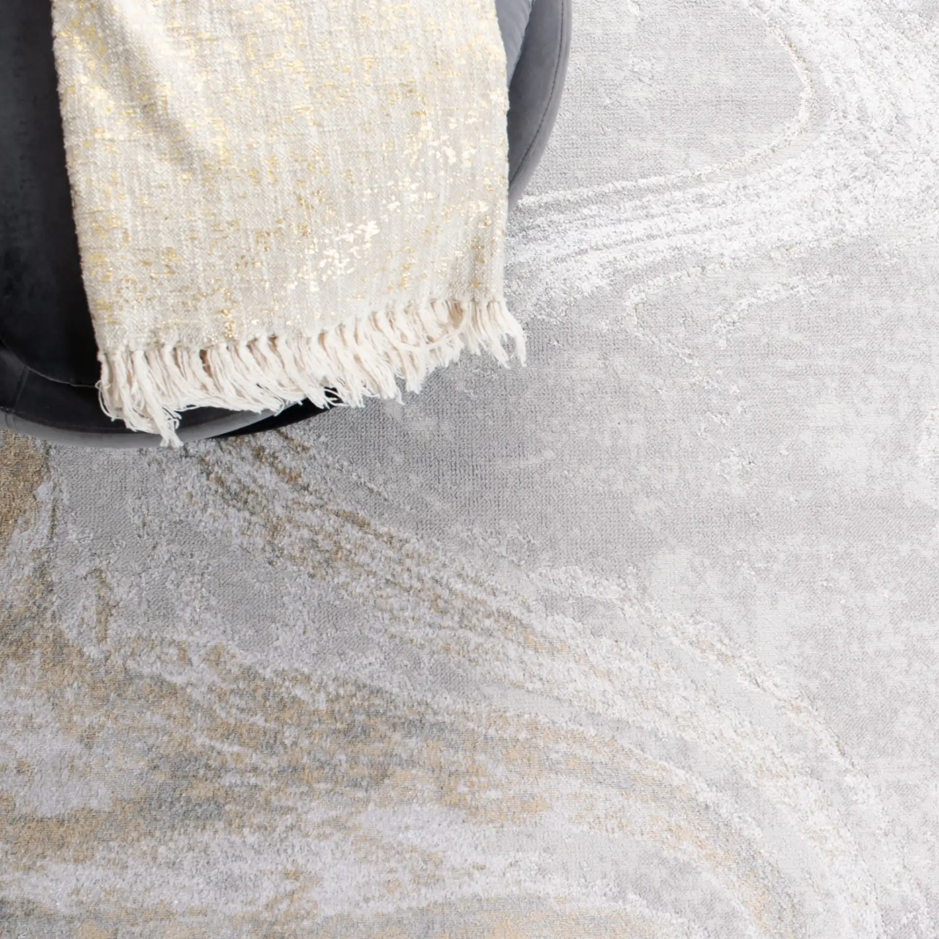 Orchard Swirl Abstract Rug in Gray / Gold in a styled room