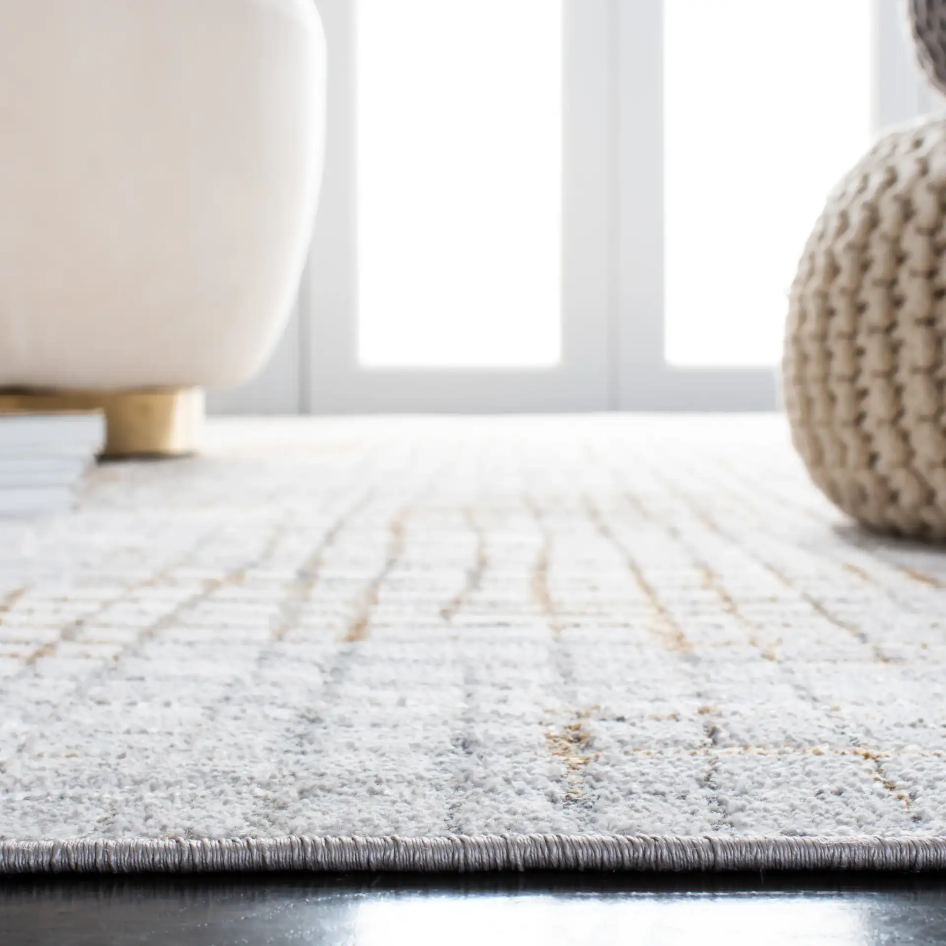 Orchard Abstract Grid Rug in Gray / Gold in a styled room