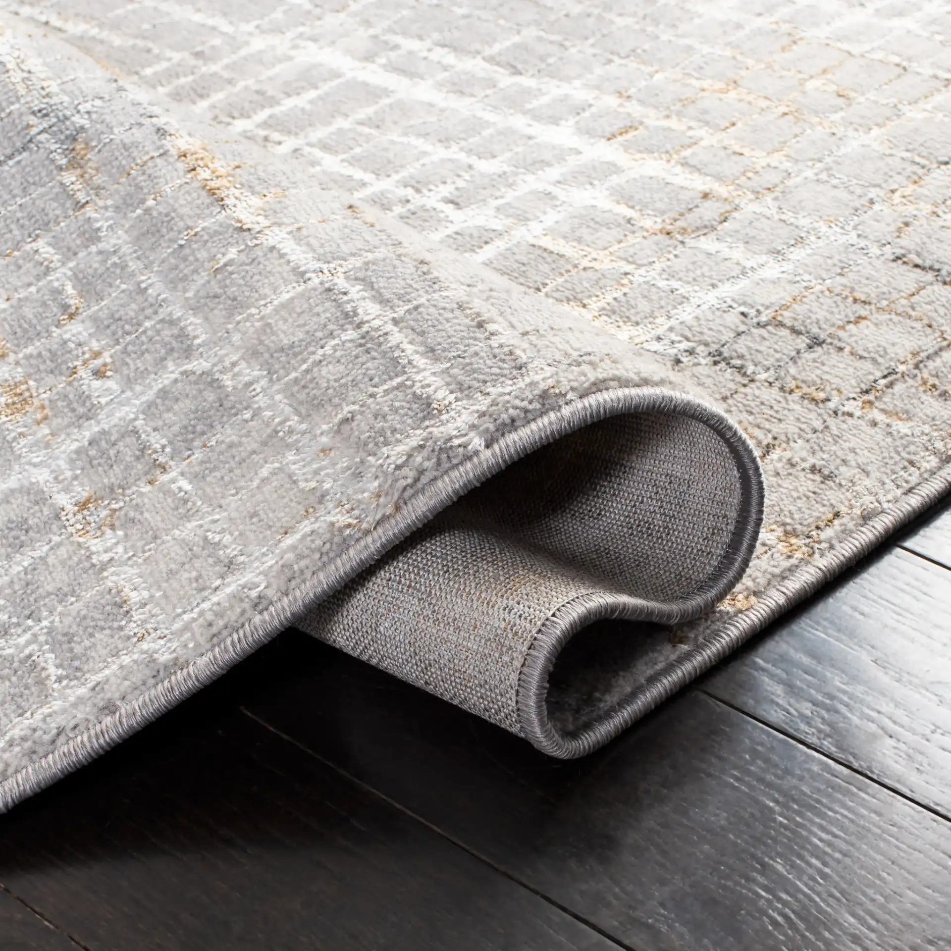 Orchard Abstract Grid Rug in Gray / Gold in a styled room