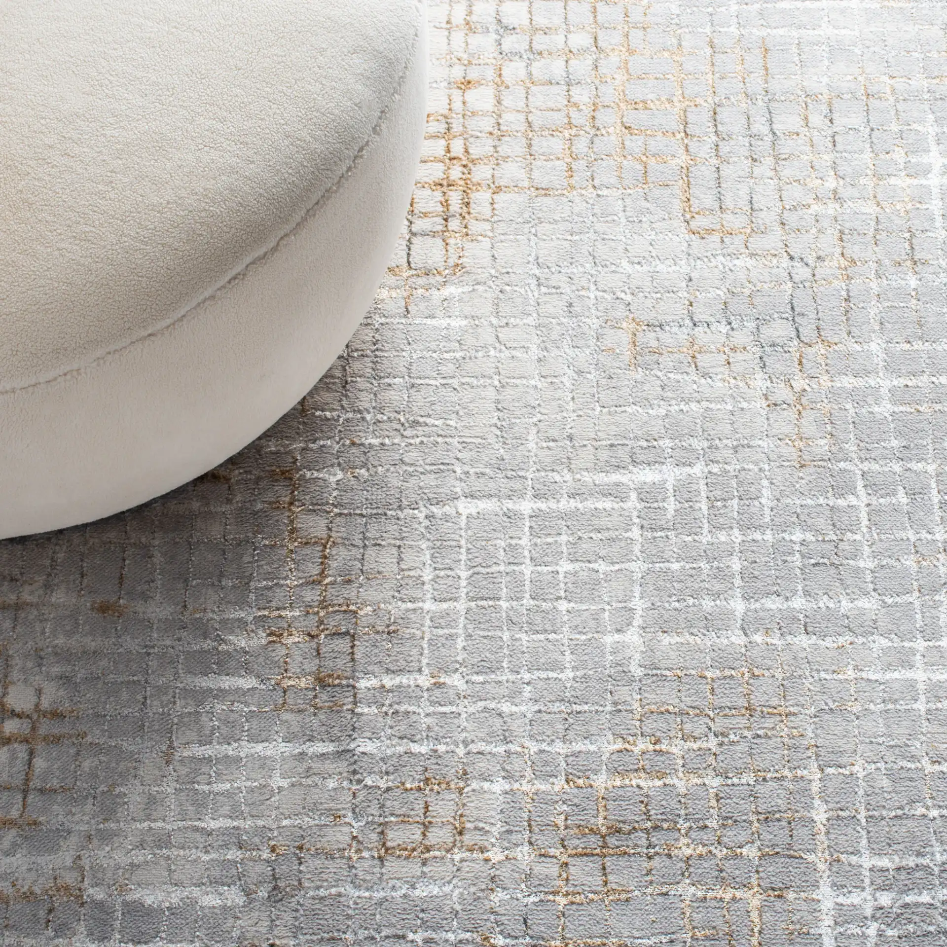 Orchard Abstract Grid Rug in Gray / Gold in a styled room