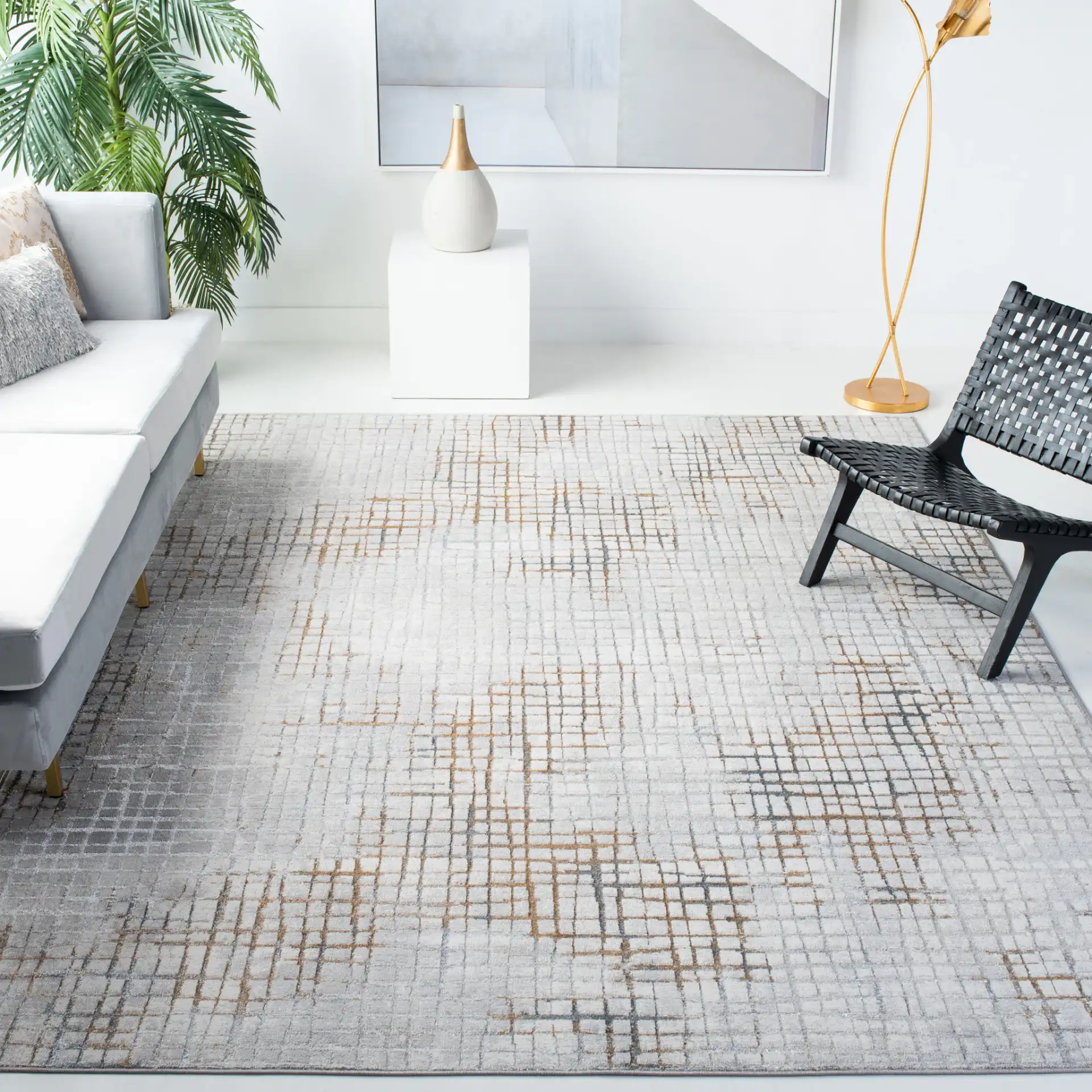 Orchard Abstract Grid Rug in Gray / Gold in a styled room