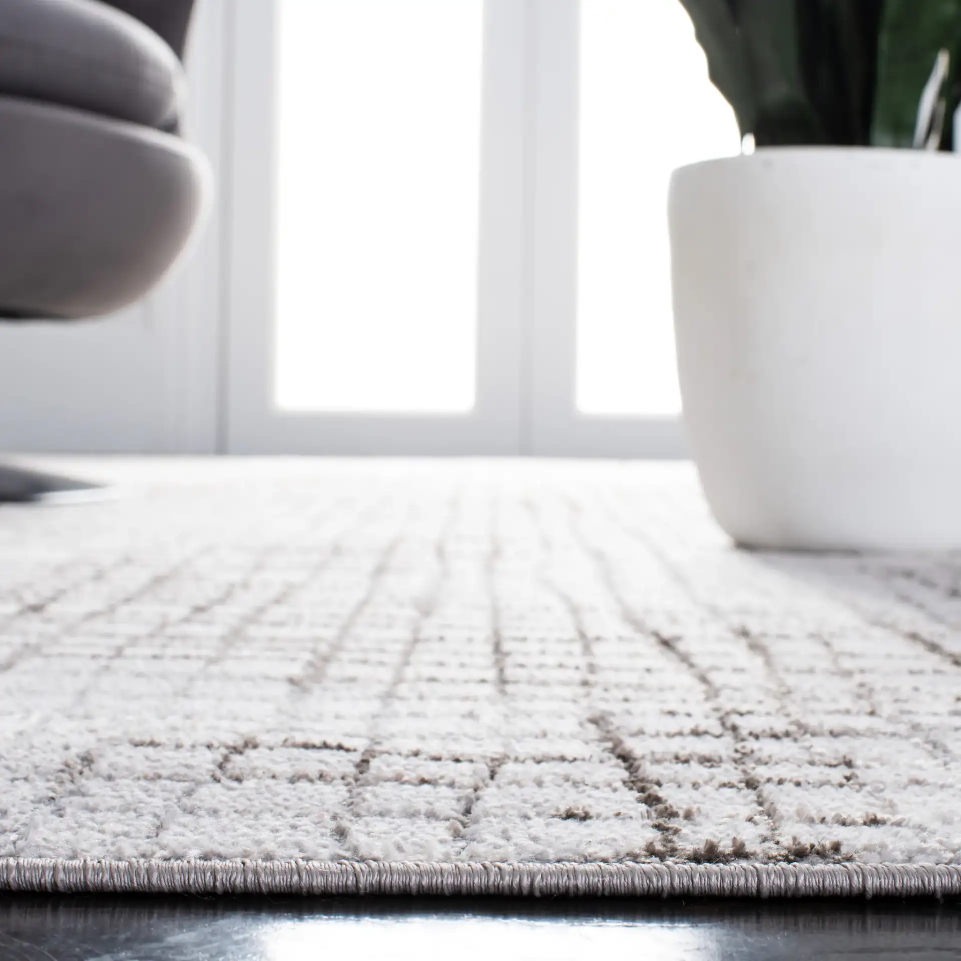 Orchard Abstract Grid Rug in Gray / Light Gray in a styled room