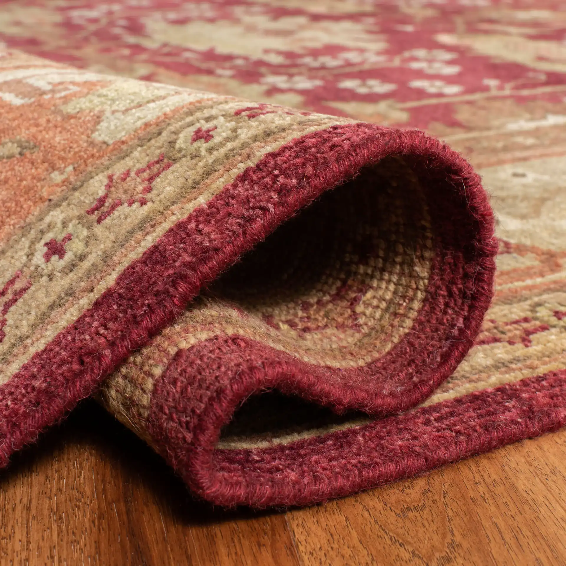 Oushak Symmetrical Floral Hand-Knotted Wool Rug in Red / Green in a styled room