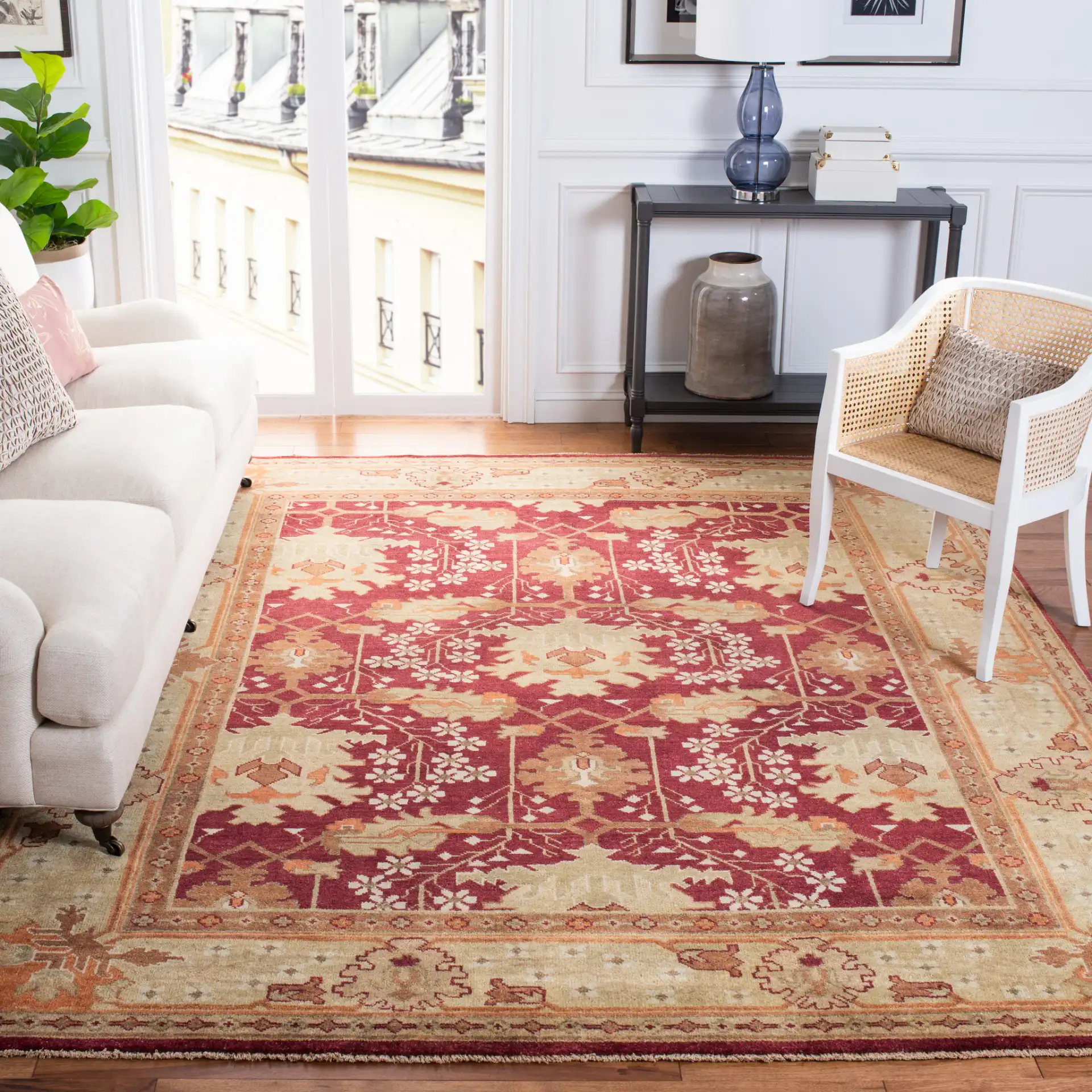 Oushak Symmetrical Floral Hand-Knotted Wool Rug in Red / Green in a styled room