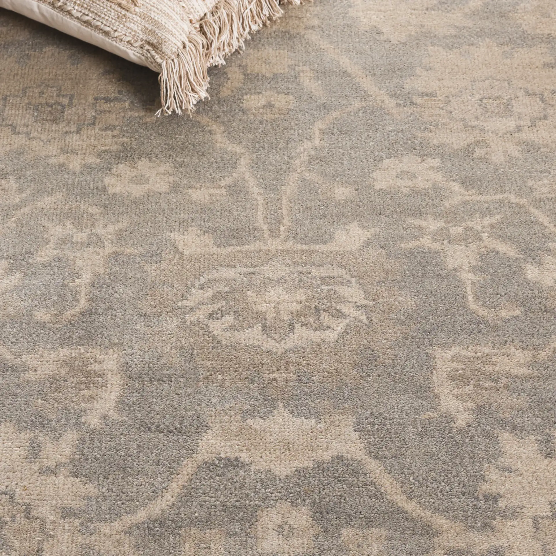 Oushak Faded Floral Bordered Hand-Knotted Wool Rug in Light Gray / Beige in a styled room