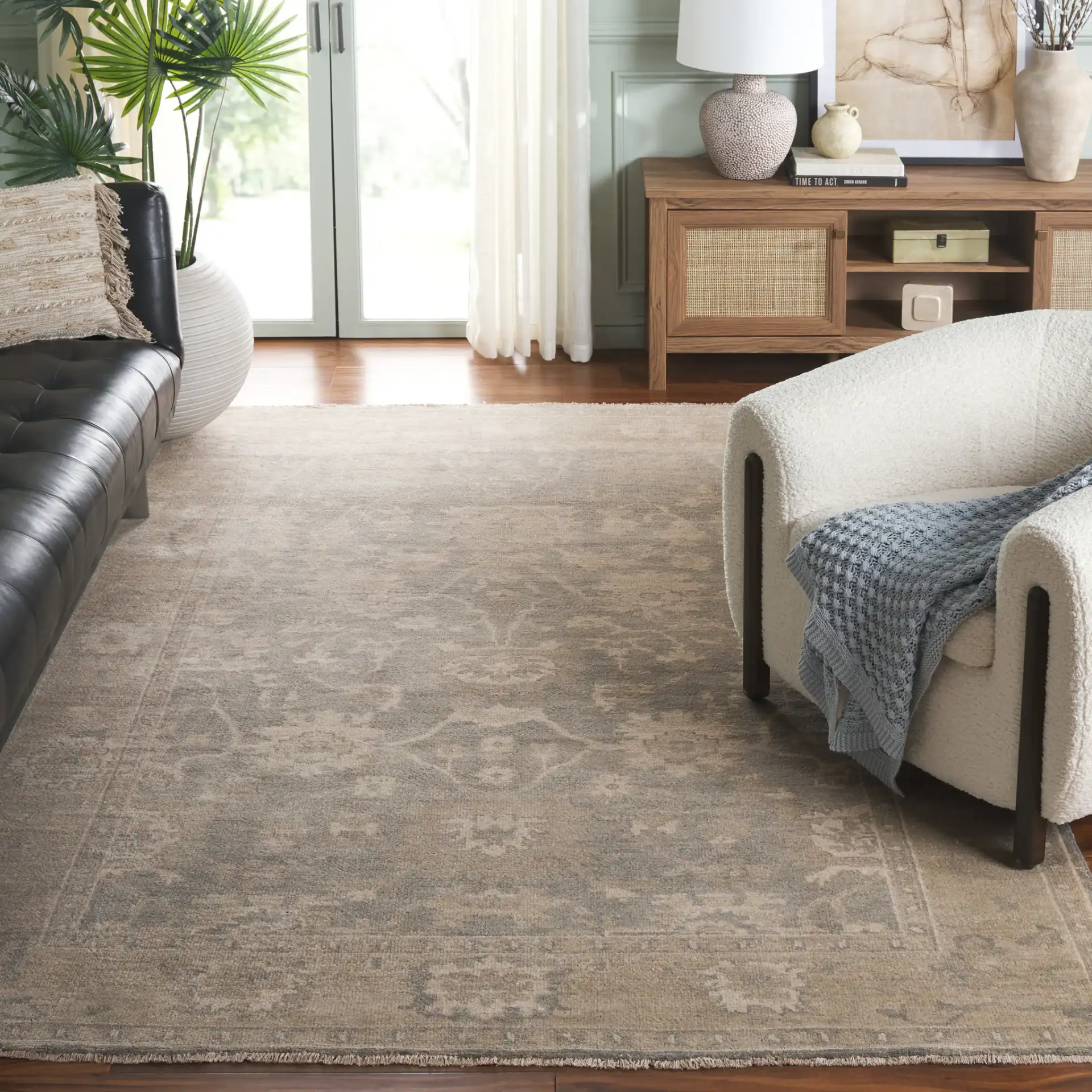 Oushak Faded Floral Bordered Hand-Knotted Wool Rug in Light Gray / Beige in a styled room