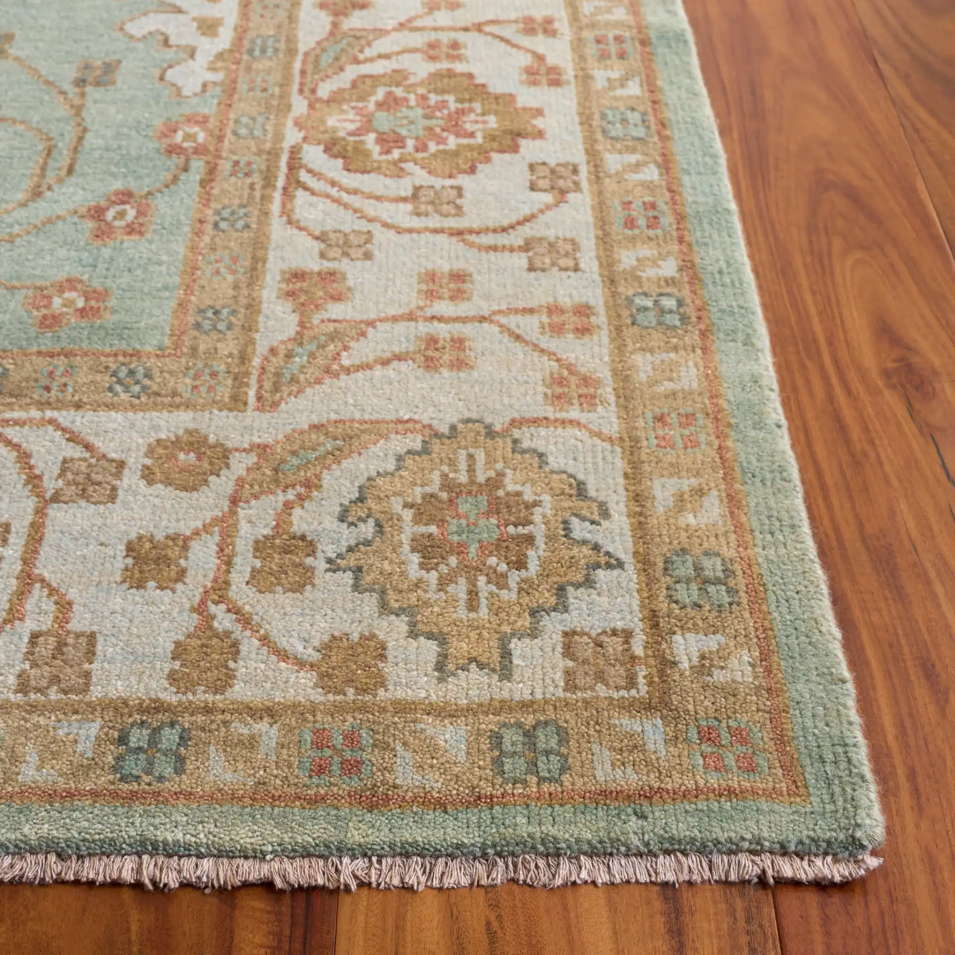 Oushak Faded Vine Hand-Knotted Wool Rug in Dark Green / Light Green in a styled room
