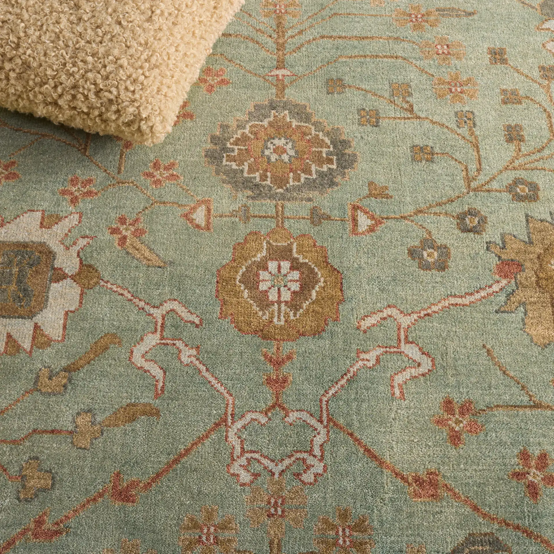Oushak Faded Vine Hand-Knotted Wool Rug in Dark Green / Light Green in a styled room