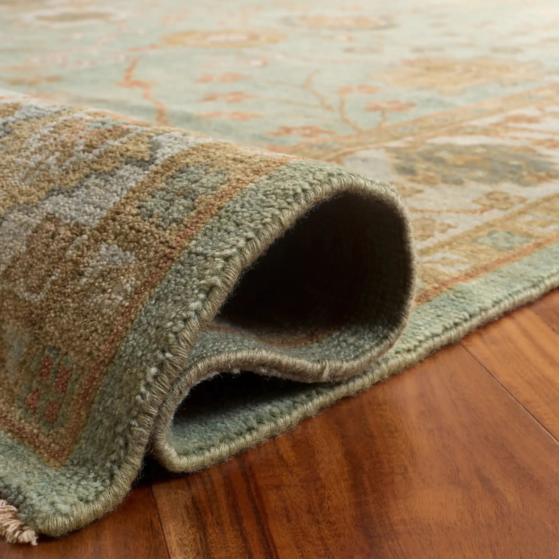 Oushak Faded Vine Hand-Knotted Wool Rug in Dark Green / Light Green in a styled room