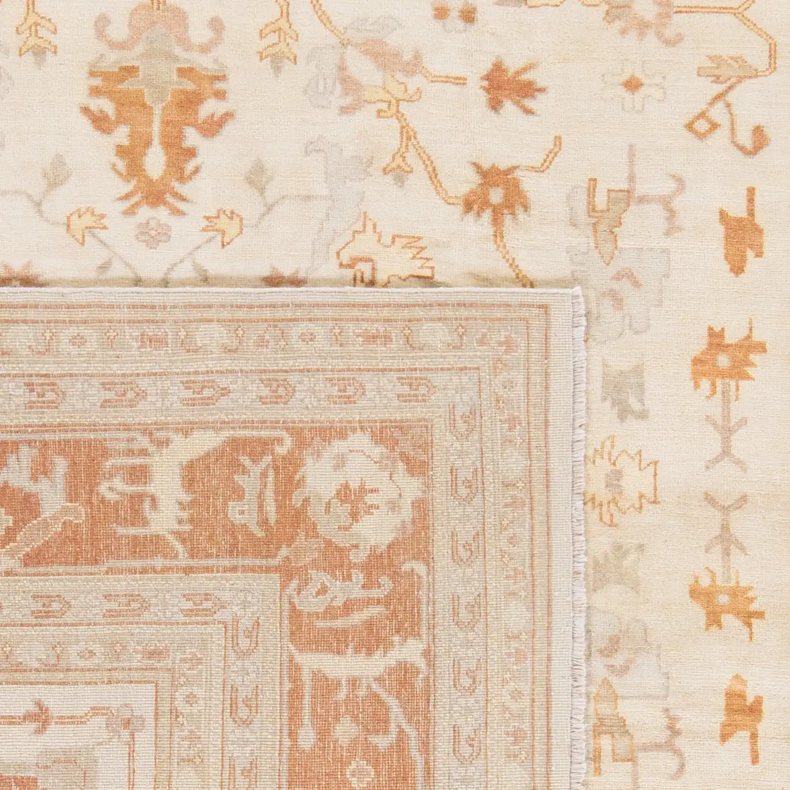Oushak Bordered Floral Hand-Knotted Wool Rug in Ivory / Rust in a styled room