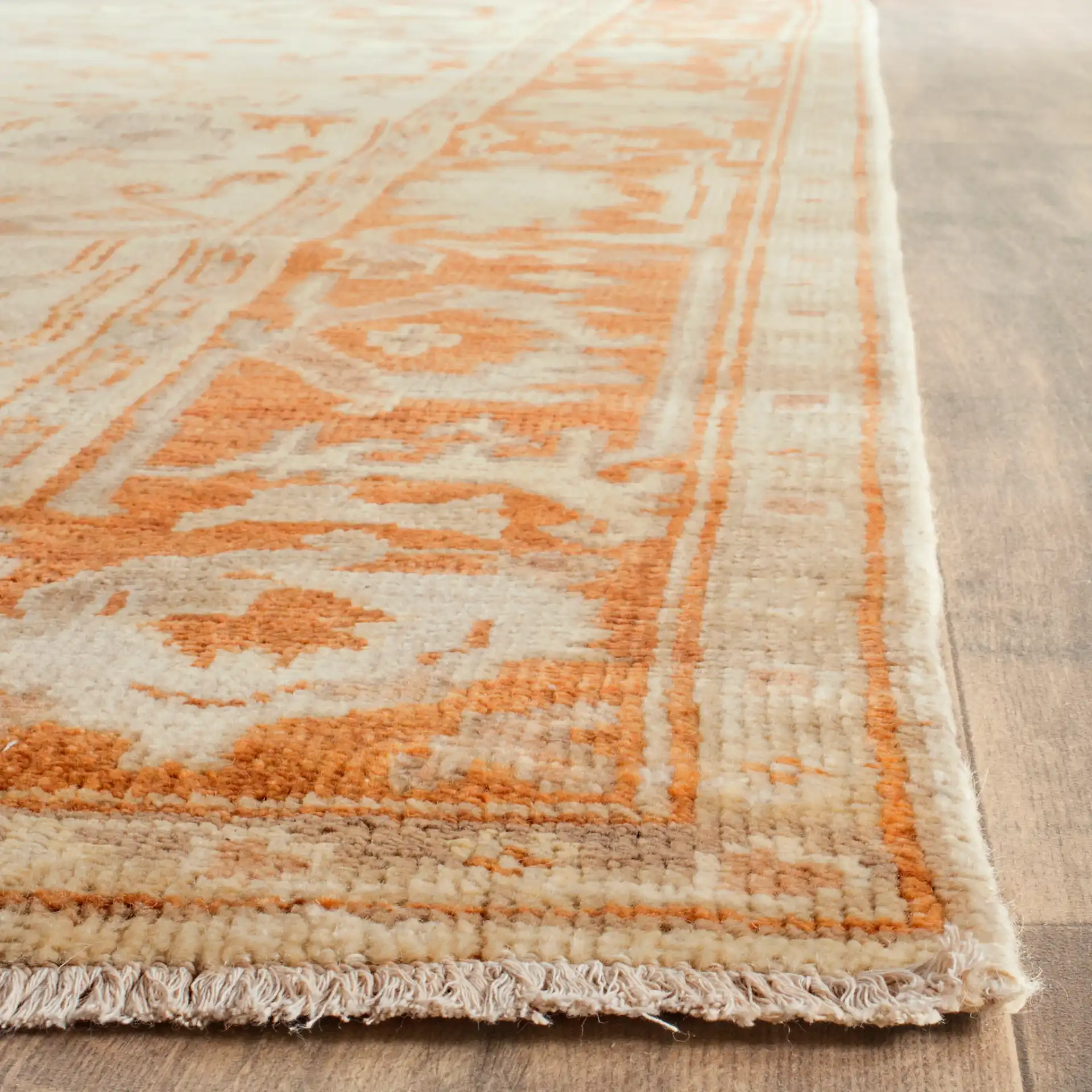 Oushak Bordered Floral Hand-Knotted Wool Rug in Ivory / Rust in a styled room