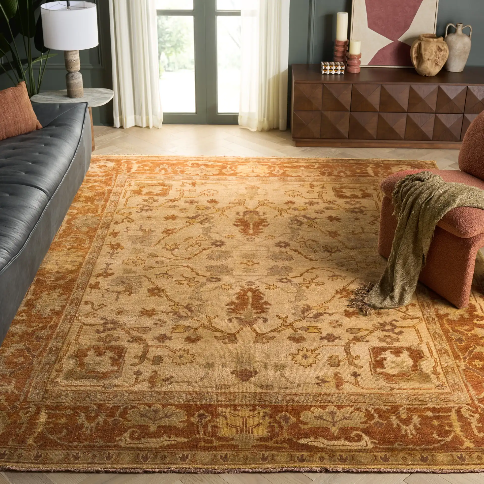 Oushak Bordered Floral Hand-Knotted Wool Rug in Ivory / Rust in a styled room