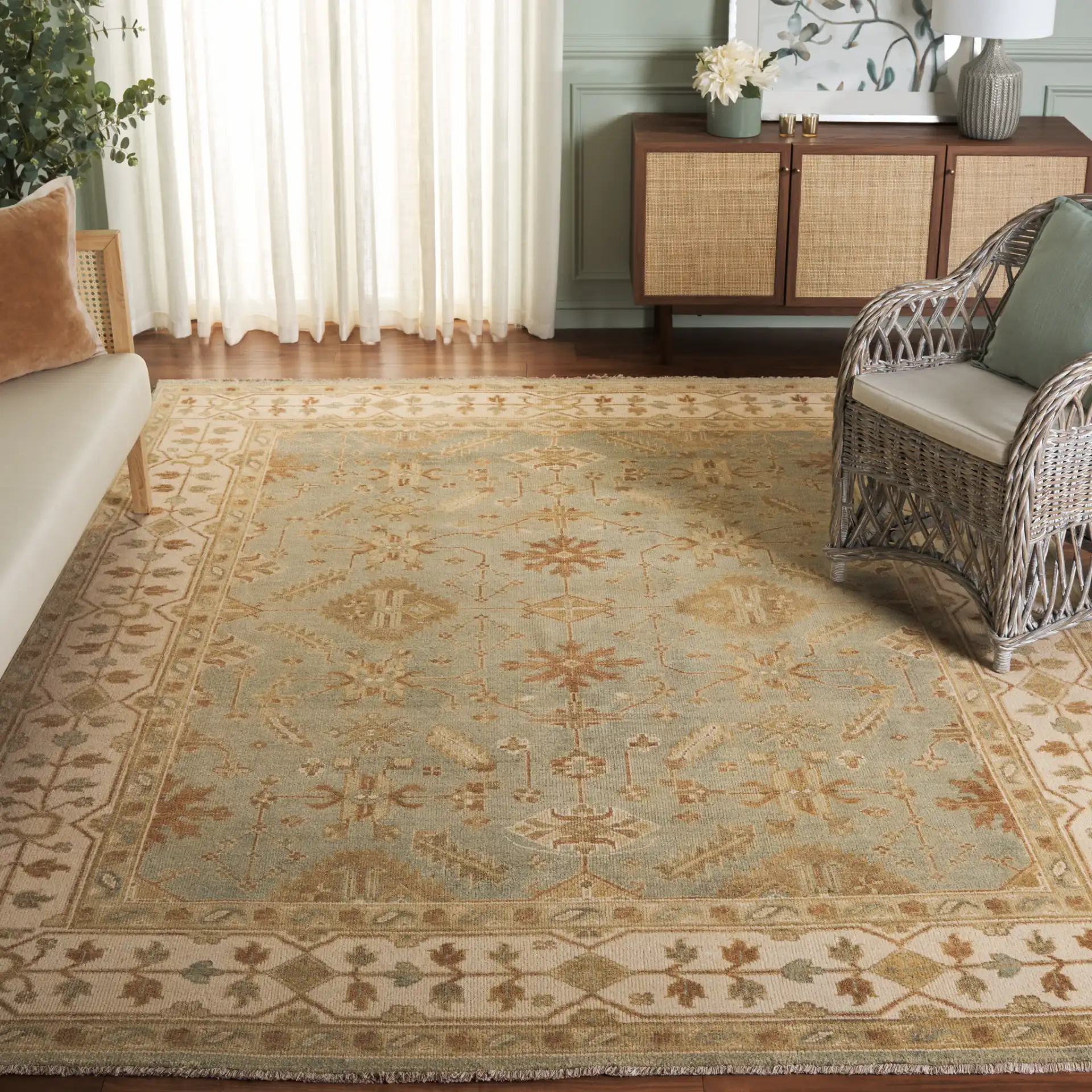 Oushak Scattered Blossom Hand-Knotted Wool Rug in Soft Green / Ivory in a styled room