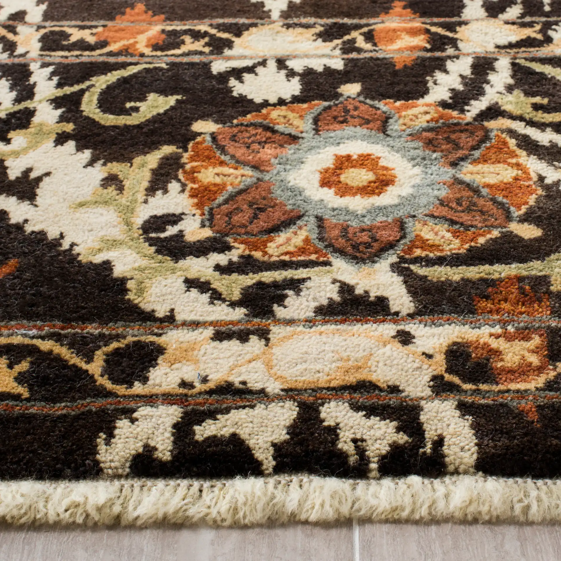Oushak Bohemian Botanical Hand-Knotted Wool Rug in Dark Brown / Multicolor in a styled room