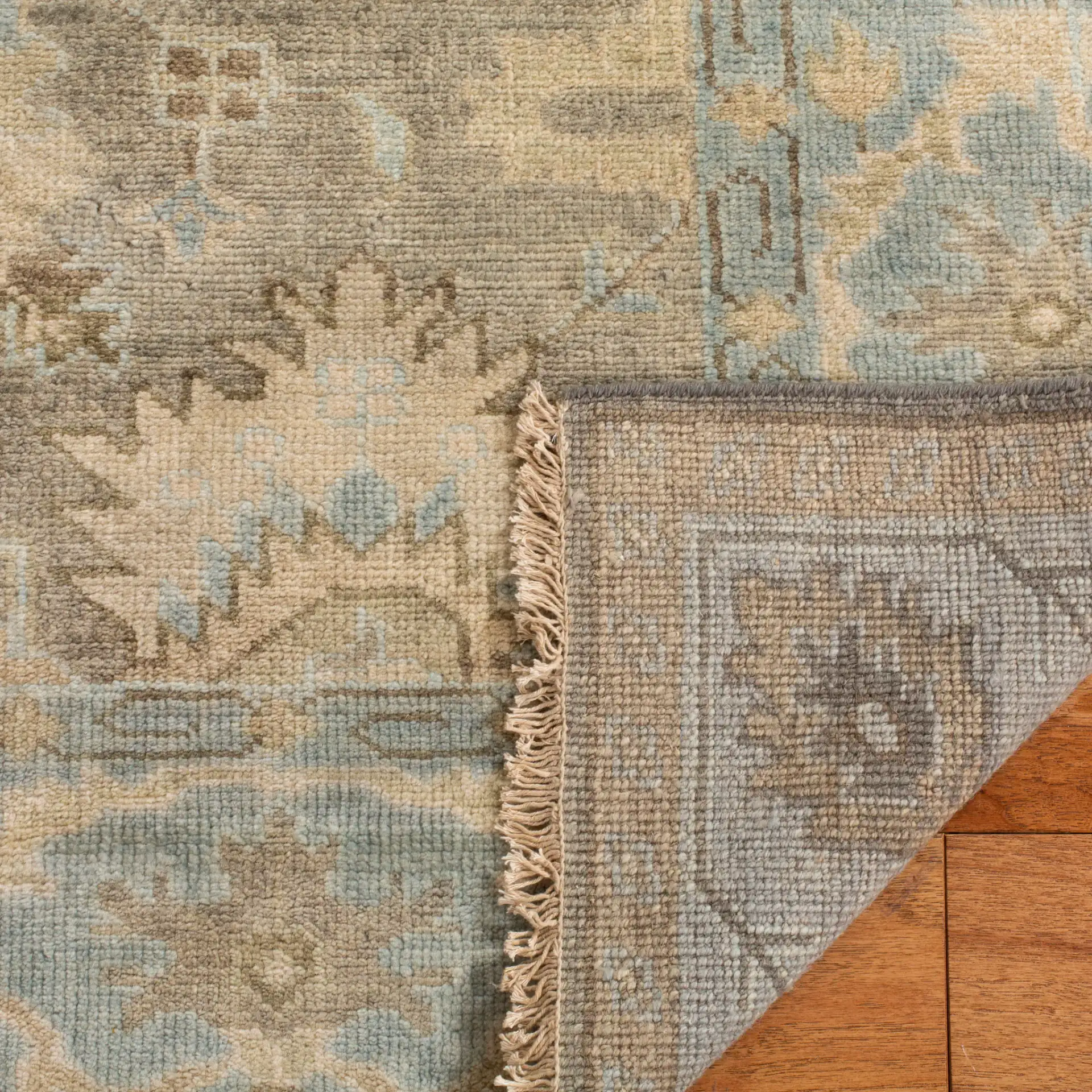 Oushak Tribal Floral Hand-Knotted Wool Rug in Brown / Blue in a styled room