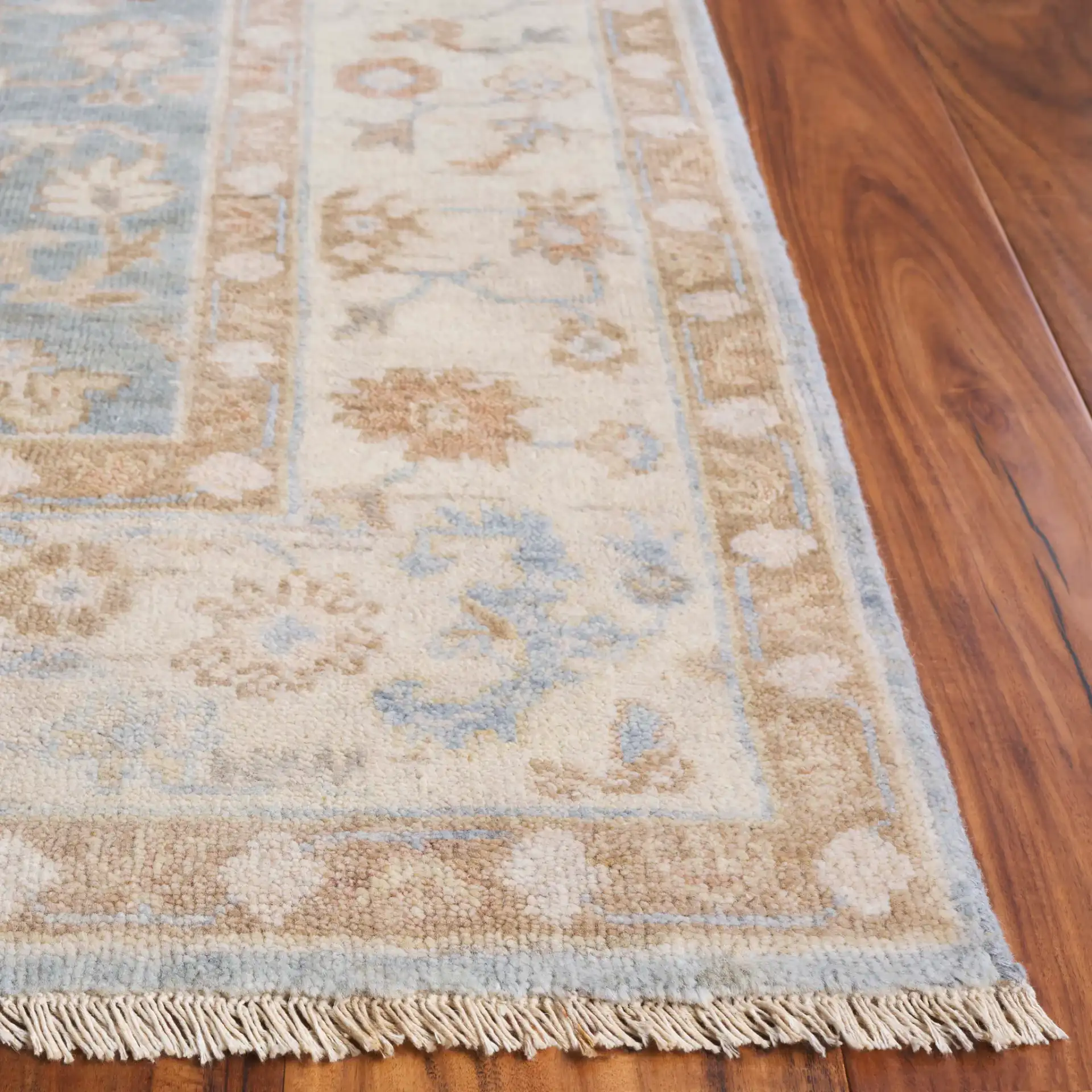 Oushak Allover Palmette Hand-Knotted Wool Rug in Light Blue / Beige in a styled room