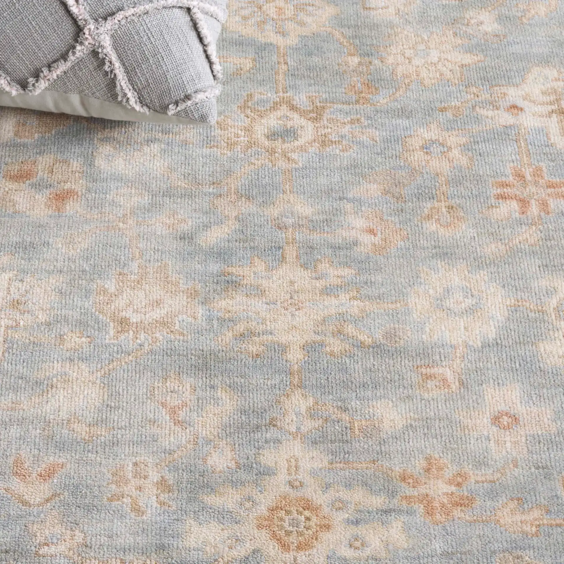 Oushak Allover Palmette Hand-Knotted Wool Rug in Light Blue / Beige in a styled room