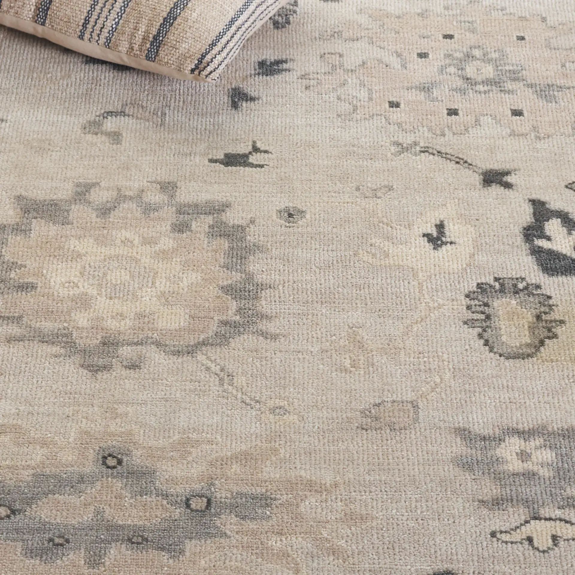 Oushak Scattered Floral Border Hand-Knotted Wool Rug in Silver / Gray in a styled room