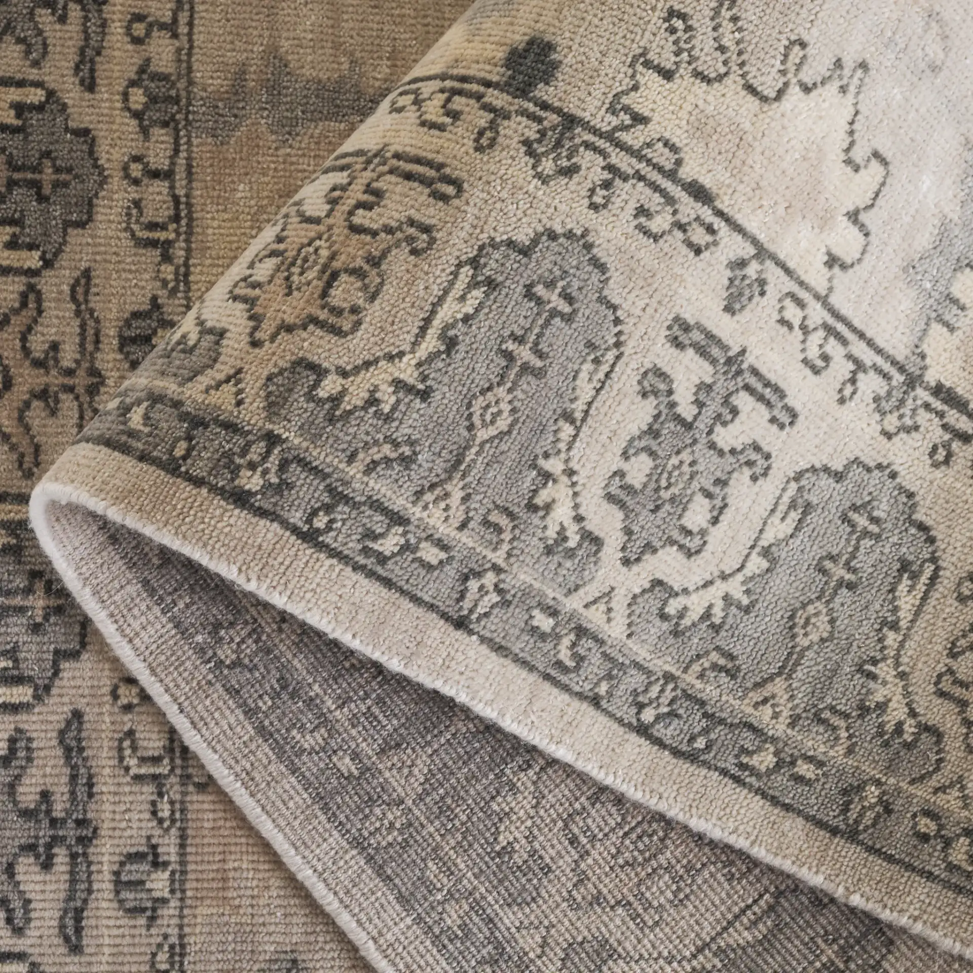 Oushak Scattered Floral Border Hand-Knotted Wool Rug in Silver / Gray in a styled room