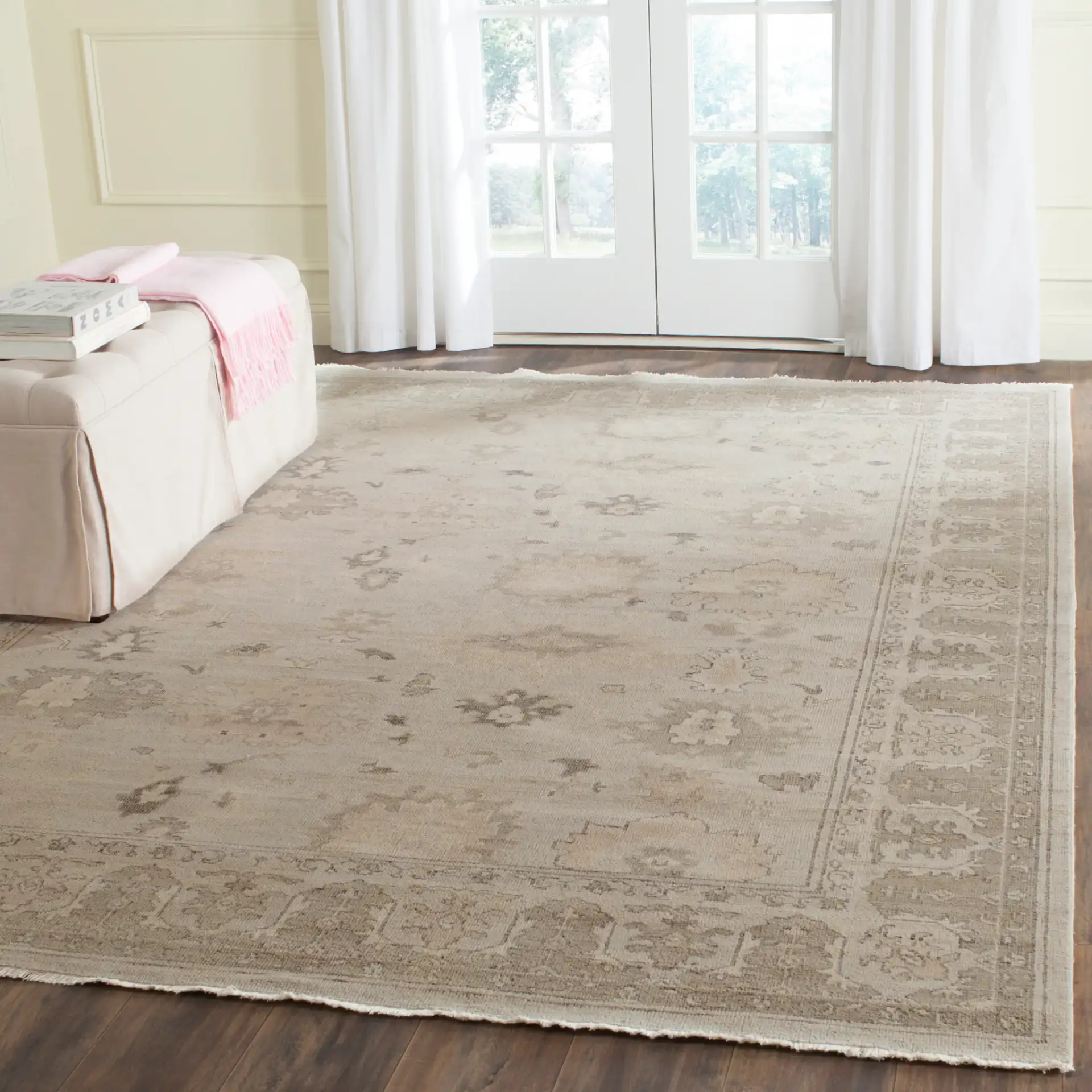 Oushak Scattered Floral Border Hand-Knotted Wool Rug in Silver / Gray in a styled room