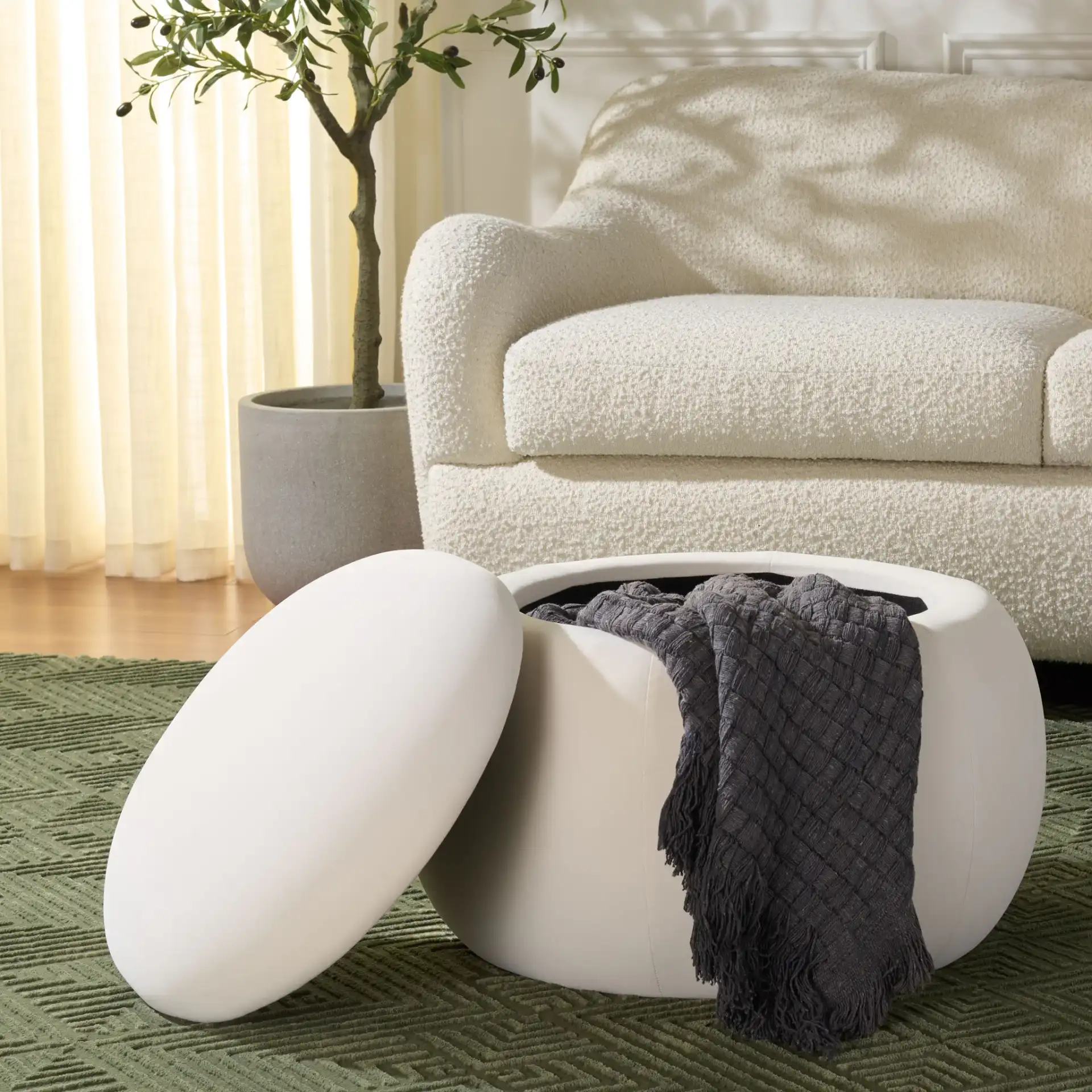 Siara Round Storage Ottoman in Cream in a styled room