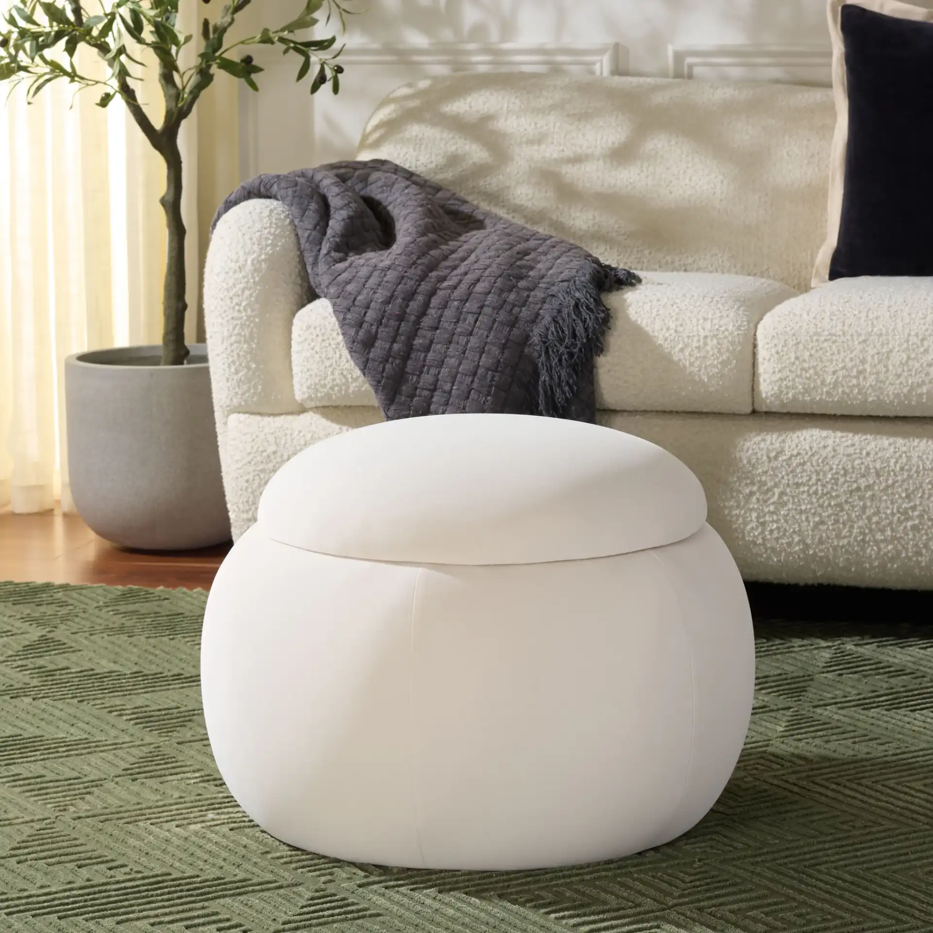 Siara Round Storage Ottoman in Cream in a styled room