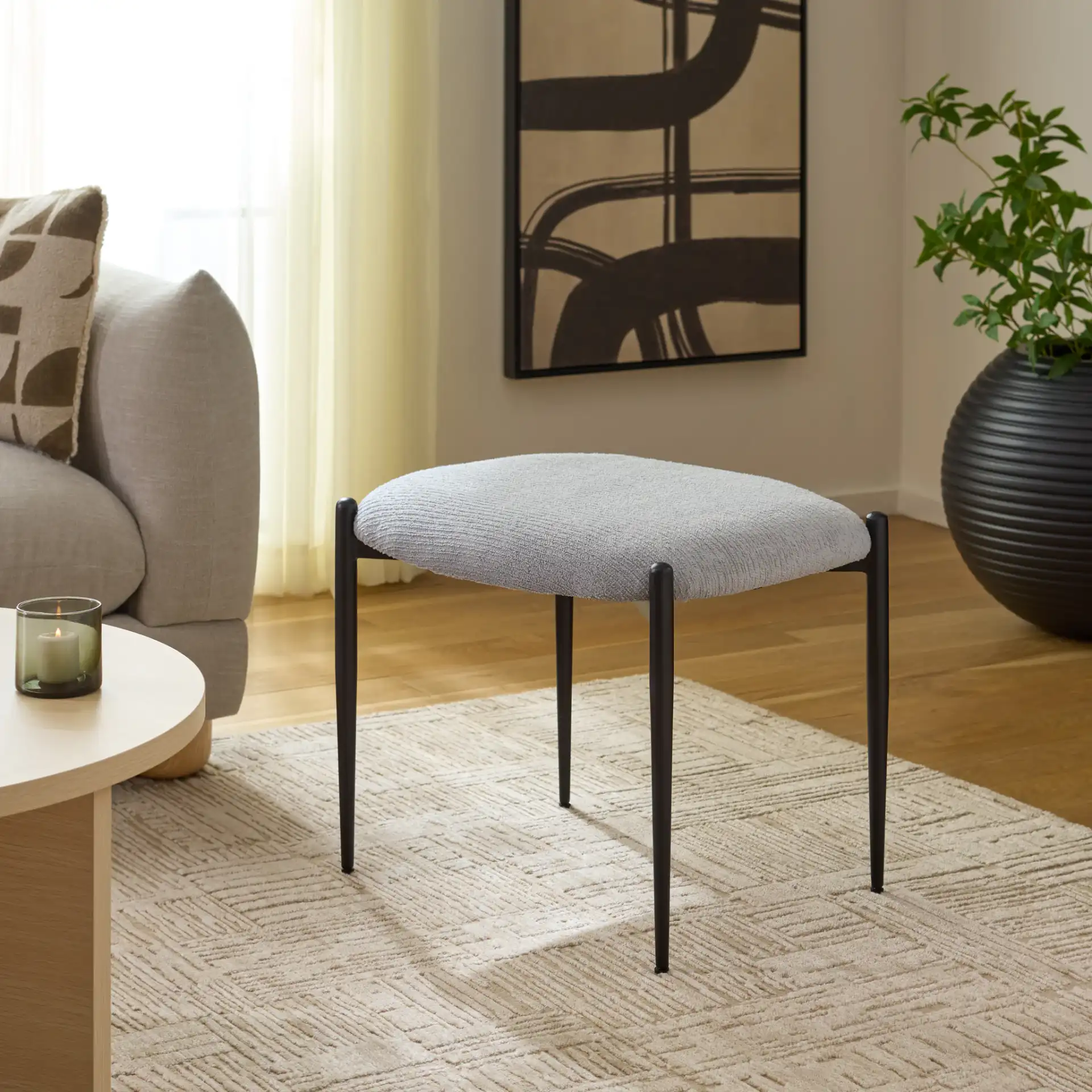 Uwe Ottoman in Gray / Black in a styled room