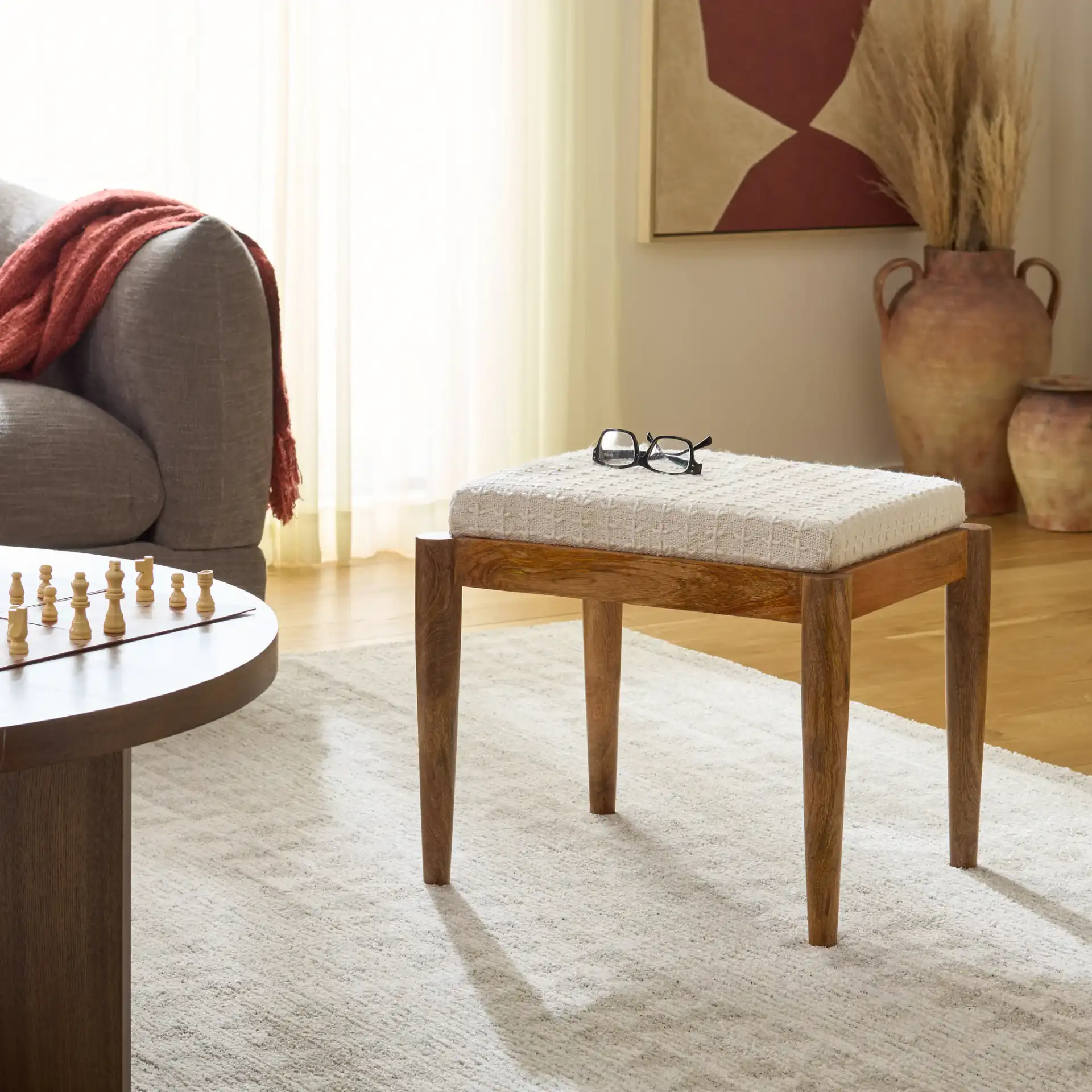Jutta Ottoman in Cream / Natural in a styled room