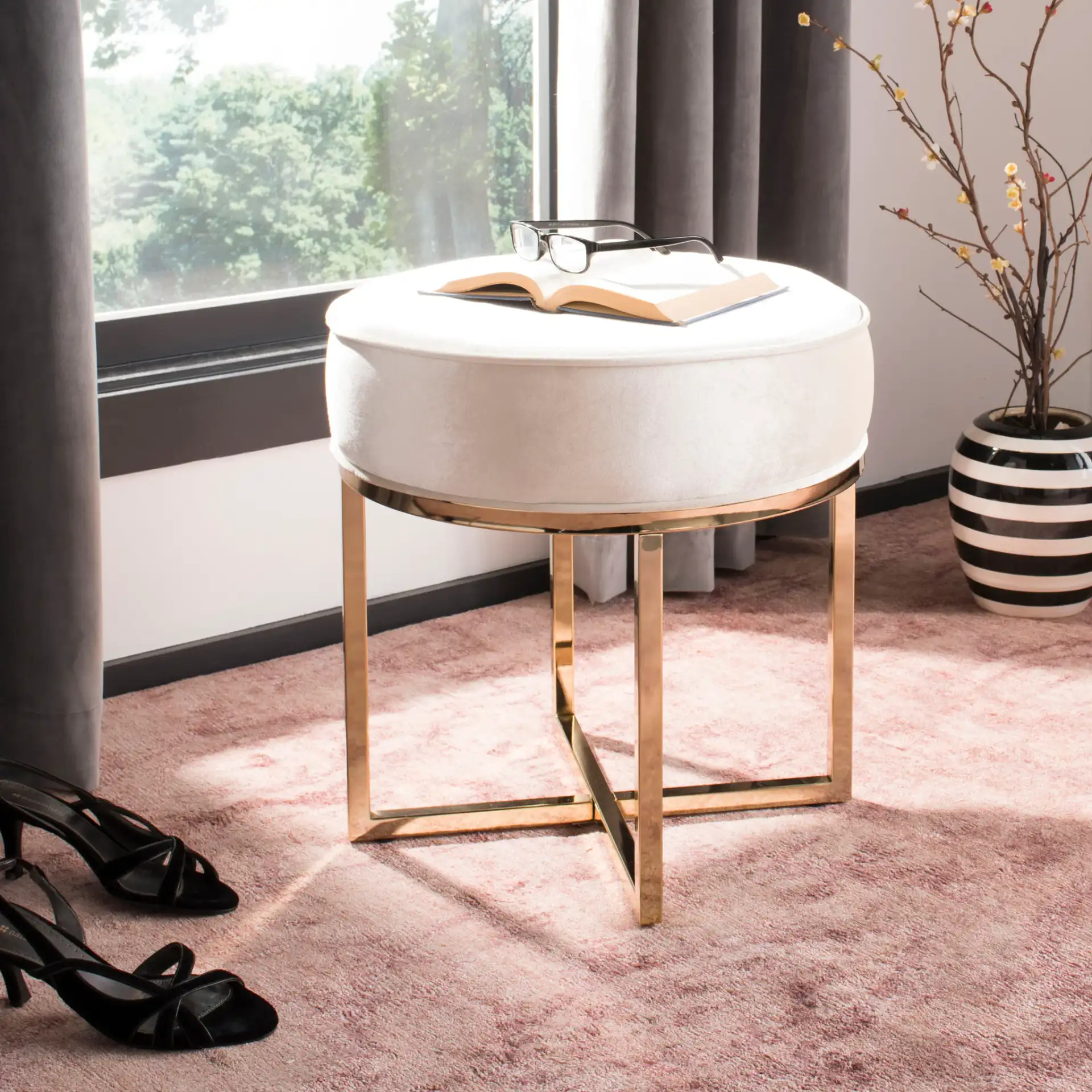 Angelea Round Ottoman in Navy Blue / Brass in a styled room
