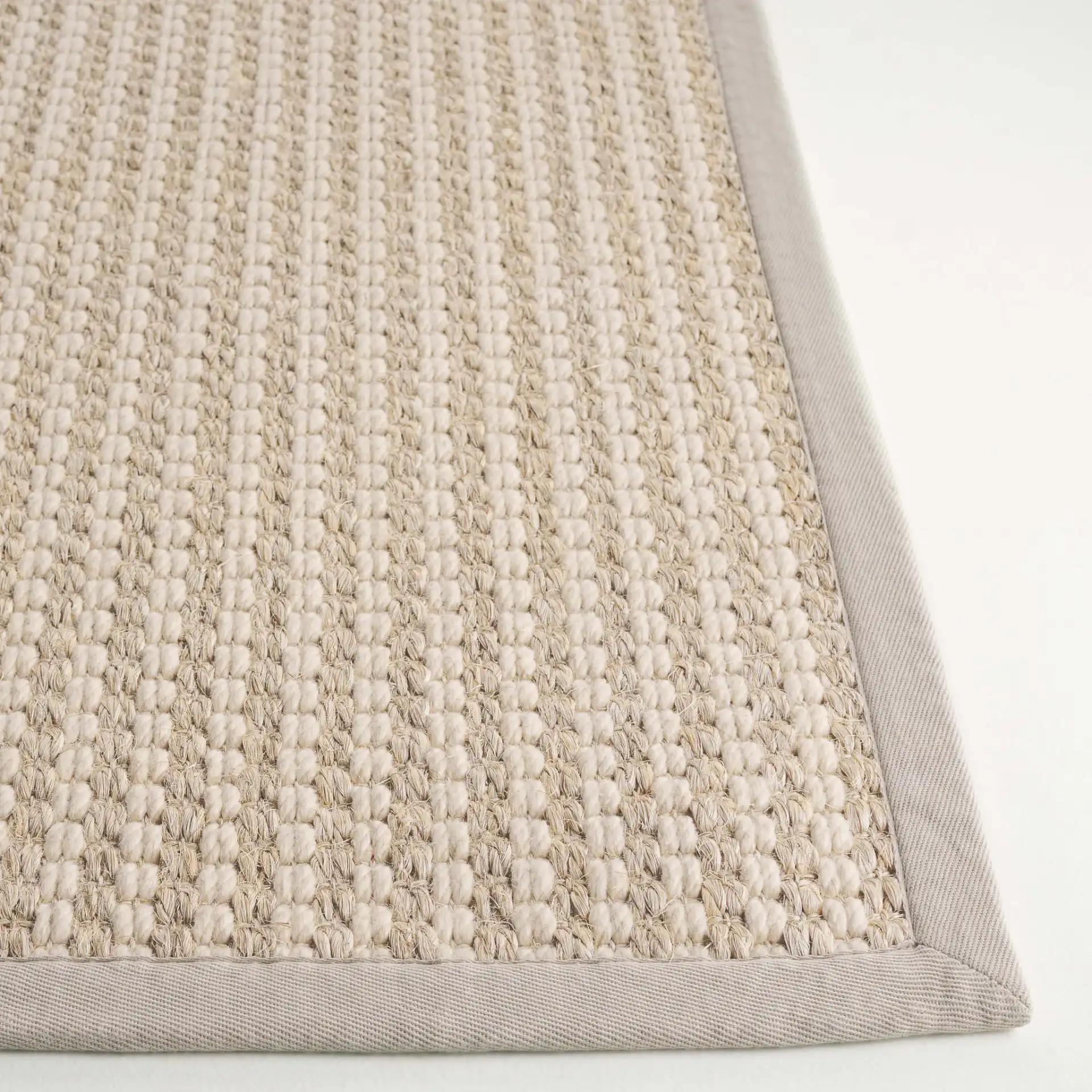 Palm Beach Waffle Bordered Rug in Ivory in a styled room