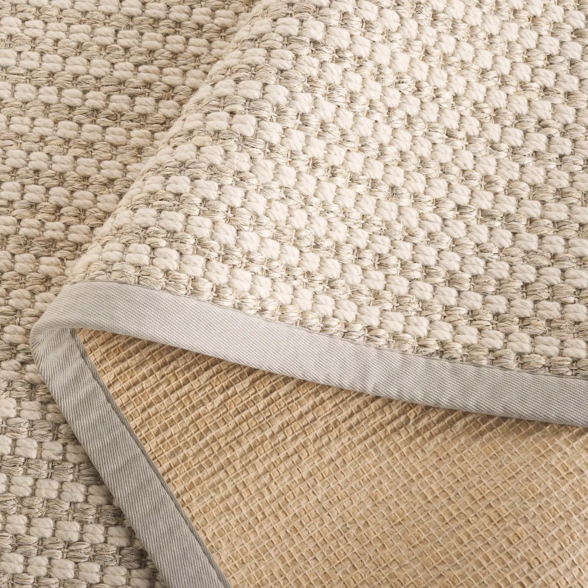 Palm Beach Waffle Bordered Rug in Ivory in a styled room