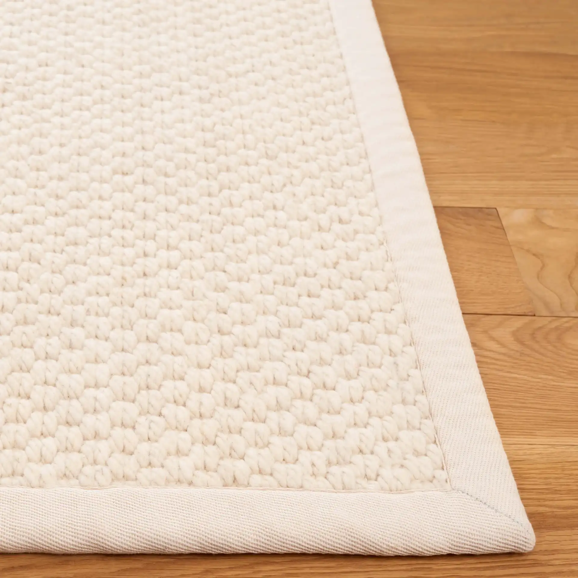 Palm Beach Basketweave Border Wool Rug in Ivory in a styled room