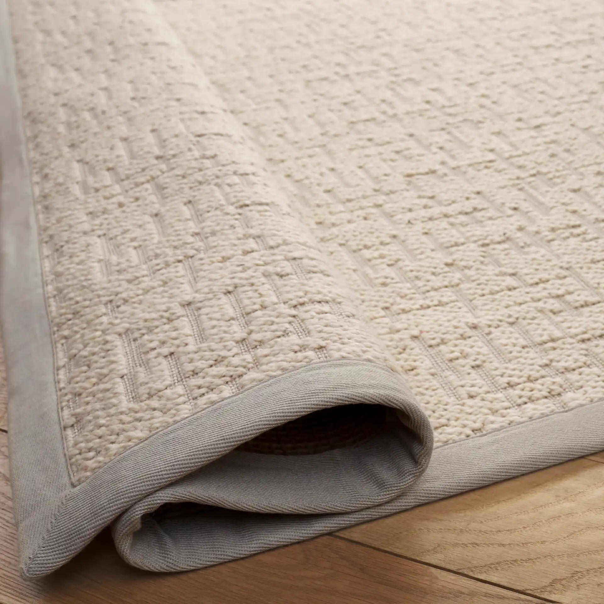 Cottage Bordered Basketweave Wool Rug in Ivory in a styled room