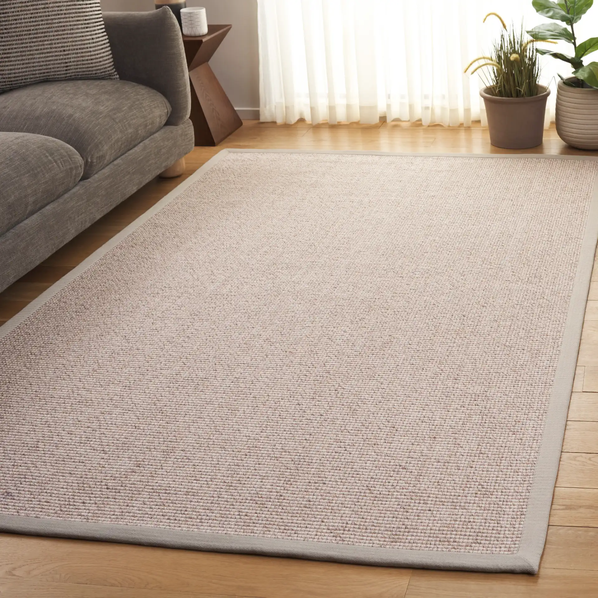 Seaside Bordered Wool Rug in Gray / Ivory in a styled room