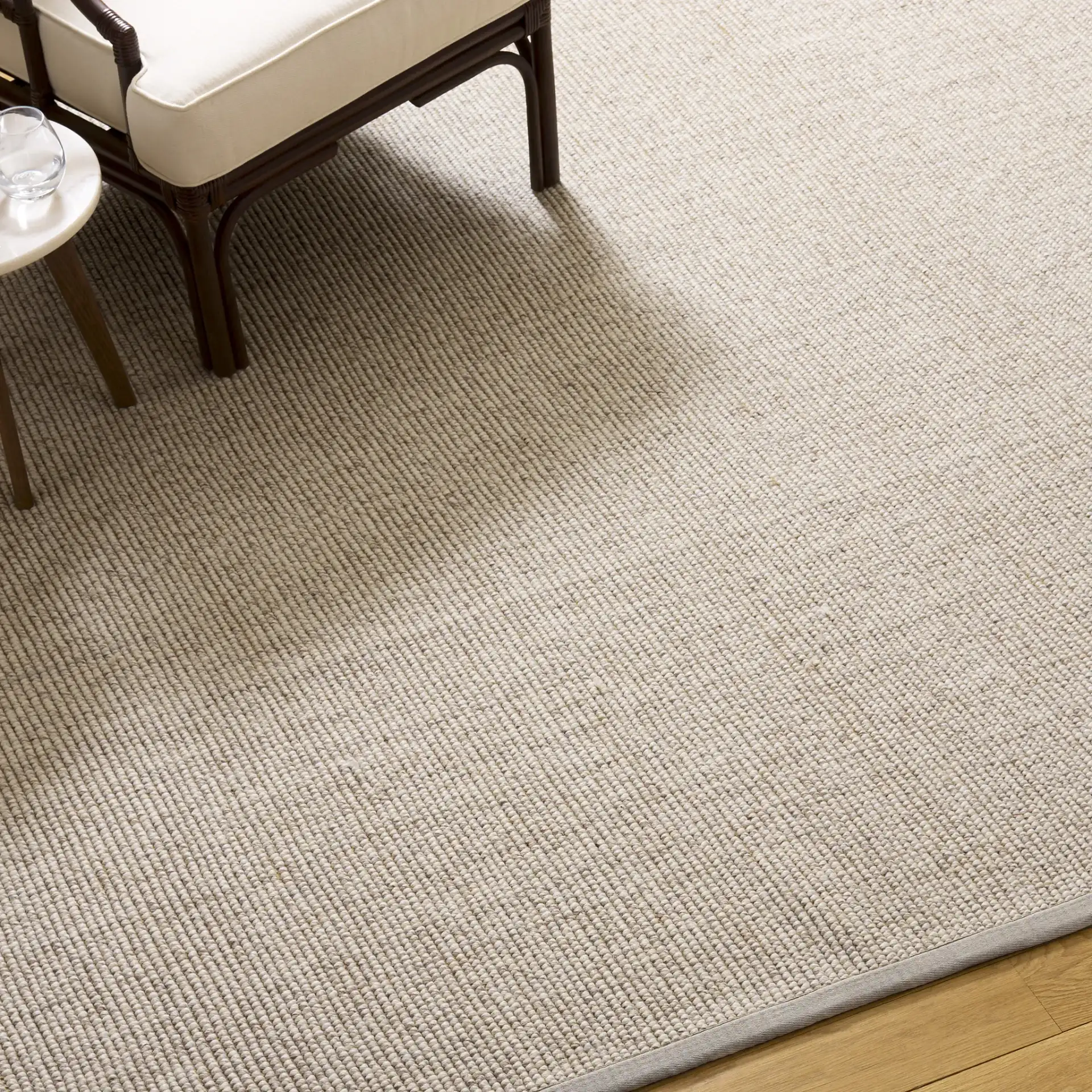 Seaside Bordered Wool Rug in Gray / Ivory in a styled room