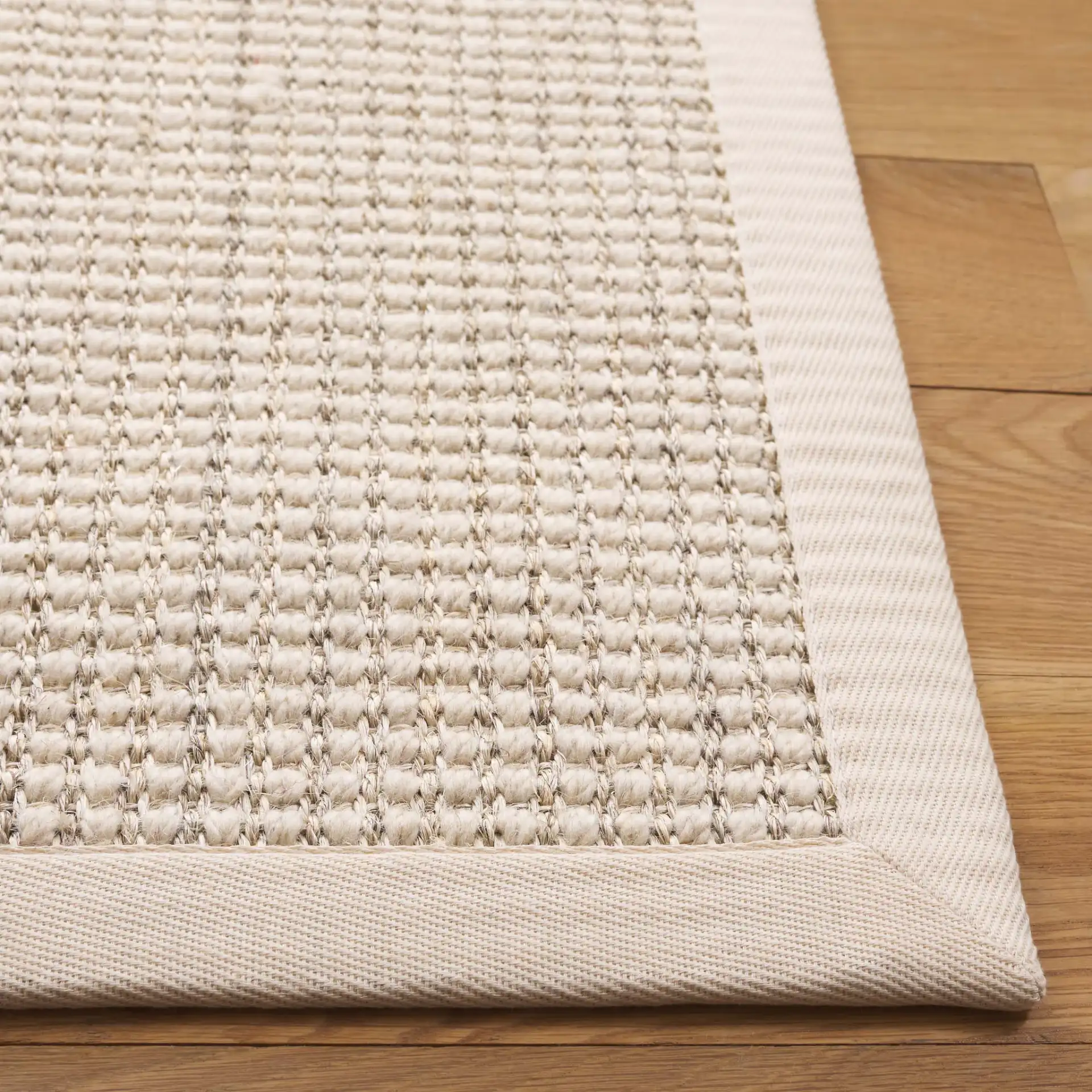 Palm Beach Grid Weave Bordered Rug in Ivory in a styled room