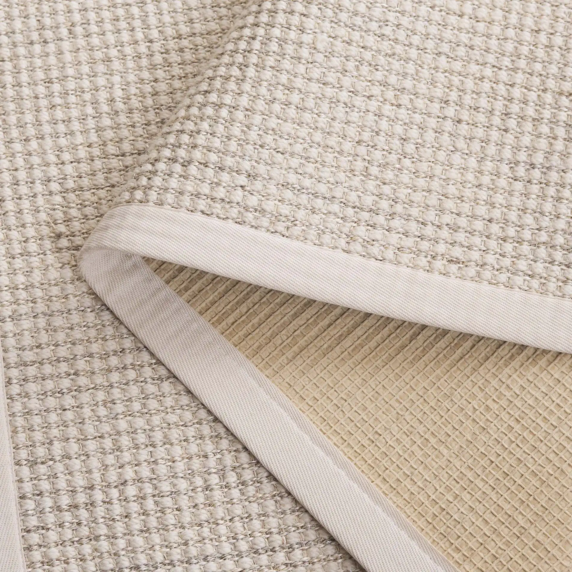 Palm Beach Grid Weave Bordered Rug in Ivory in a styled room