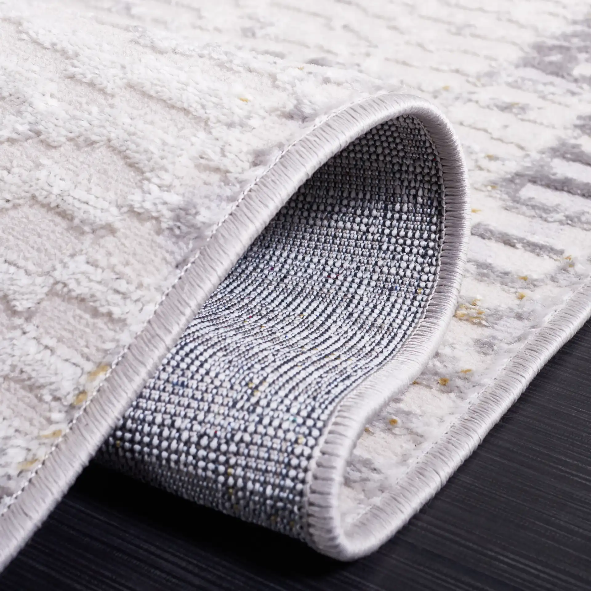 Palma Faded Abstract Rug in Beige / Light Gray in a styled room