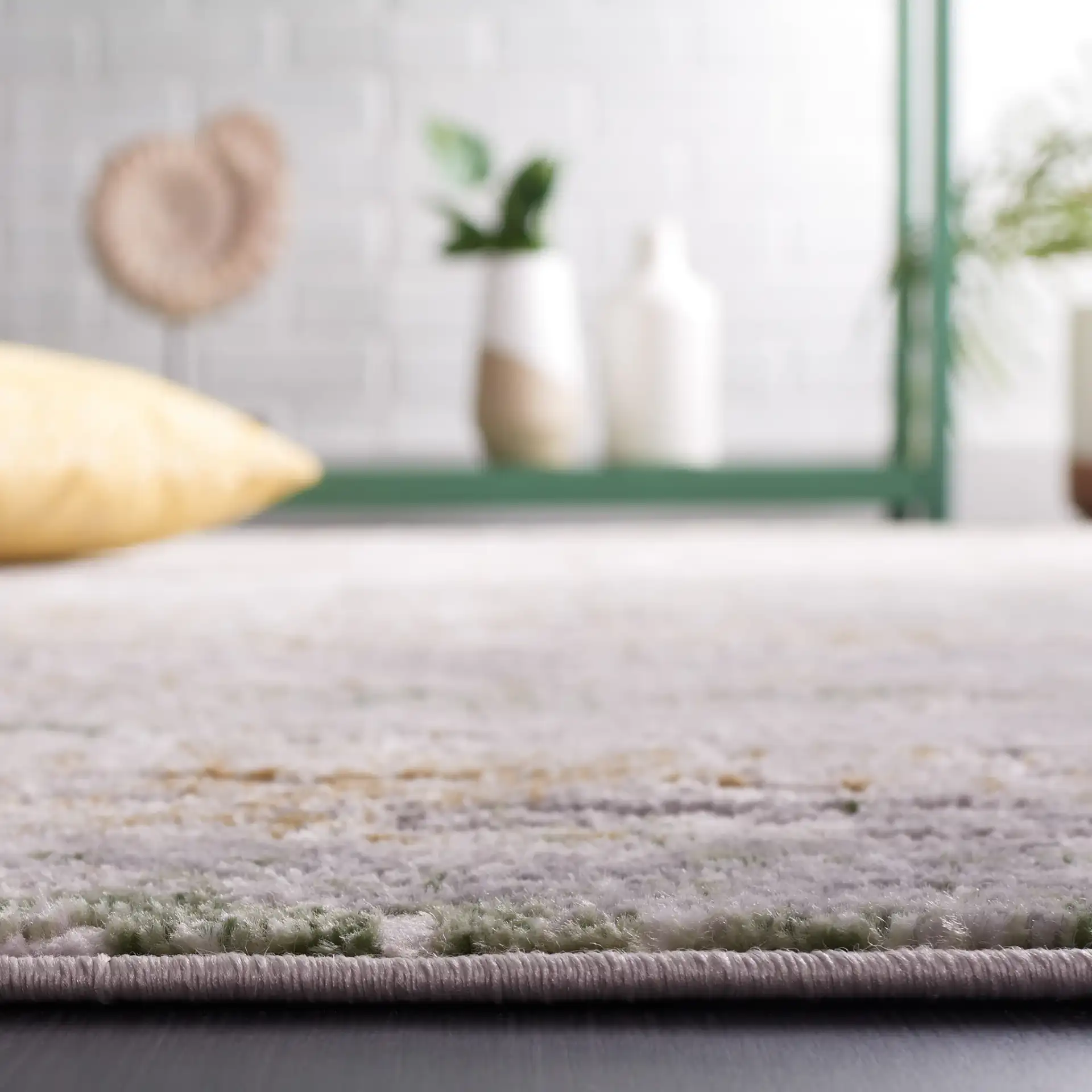 Palma Distressed Abstract Rug in Gray / Green in a styled room