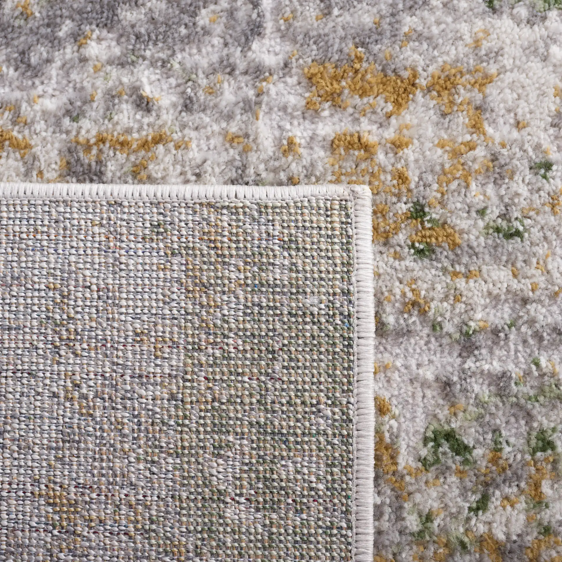 Palma Distressed Abstract Rug in Gray / Green in a styled room
