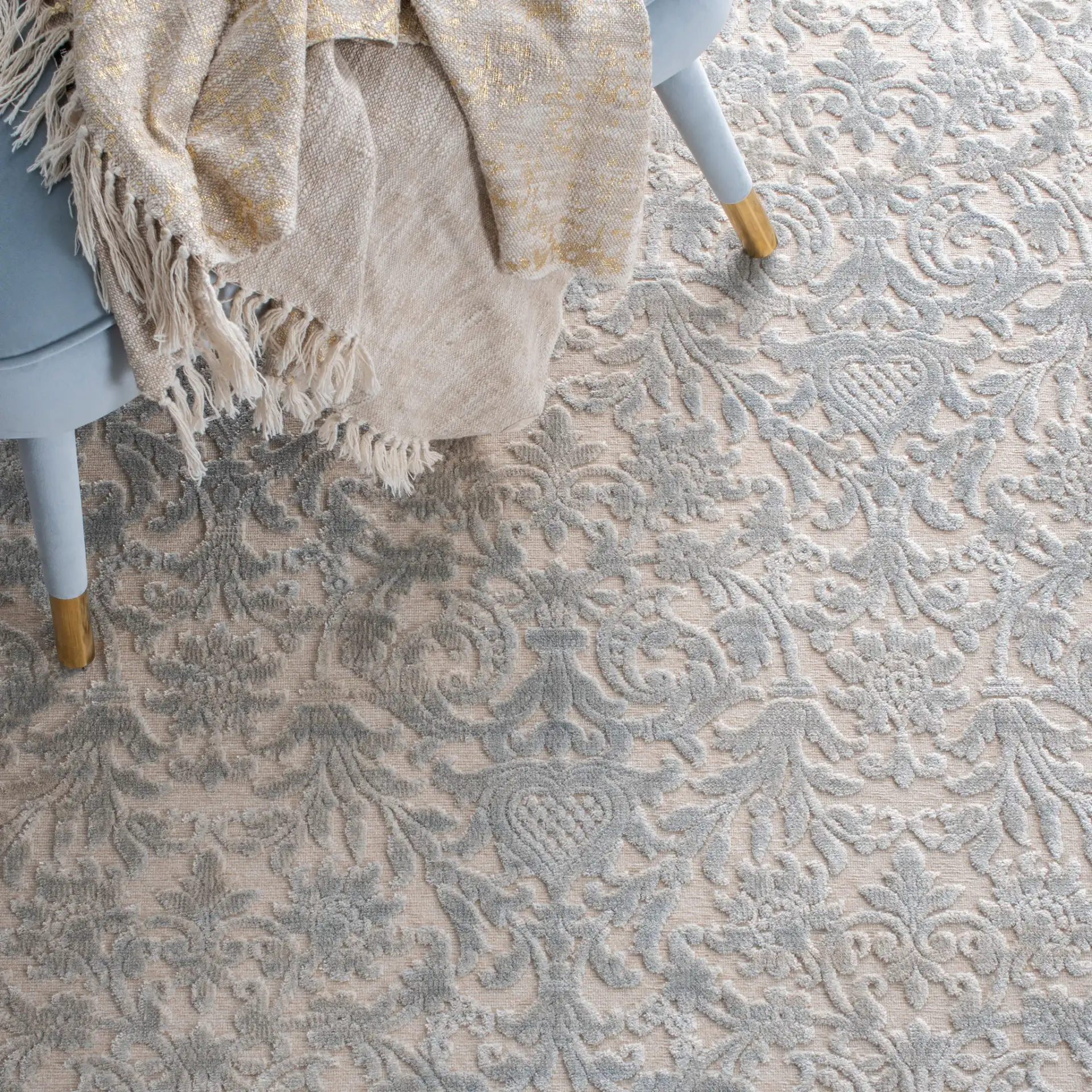 Paradise Damask Bordered Rug in Cream / Slate Blue in a styled room