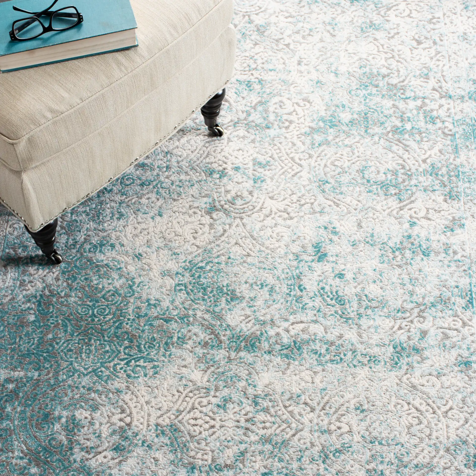 Passion Distressed Floral Bordered Rug in Turquoise / Ivory in a styled room