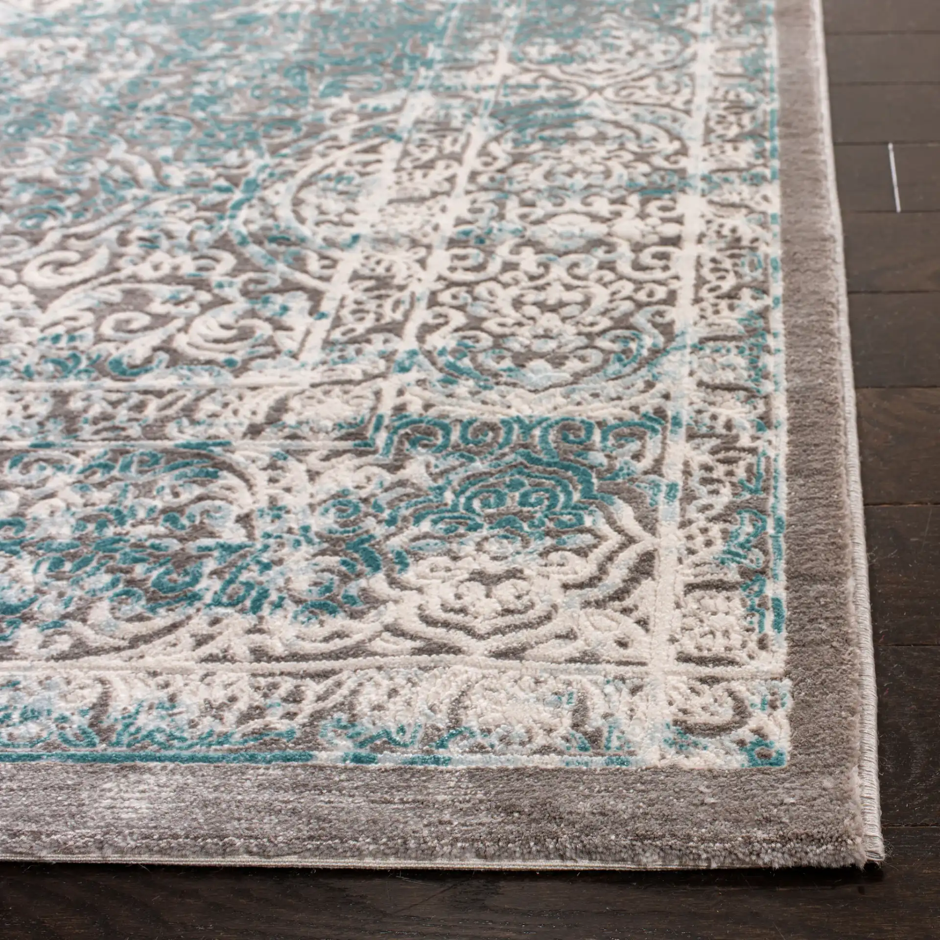 Passion Distressed Floral Bordered Rug in Turquoise / Ivory in a styled room