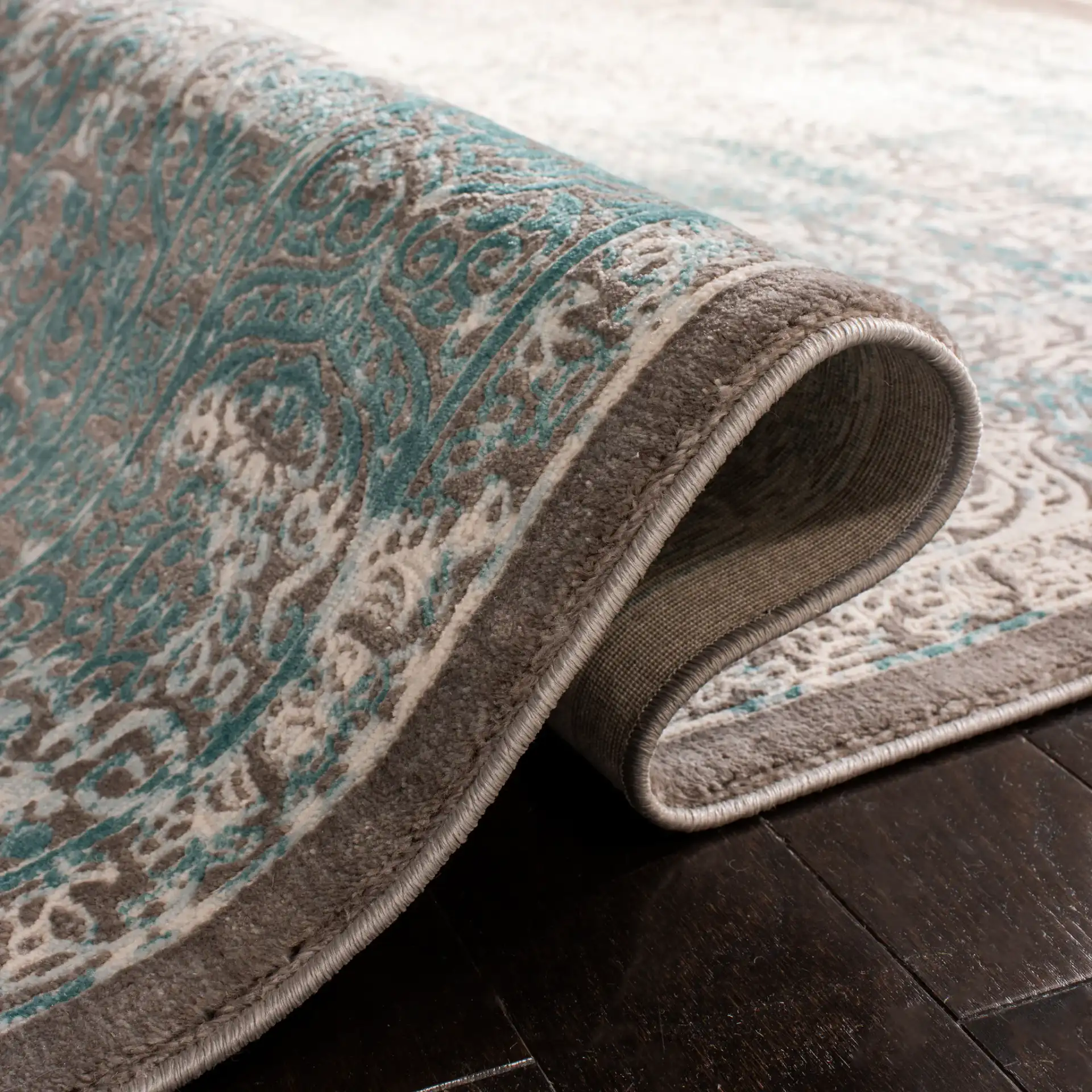 Passion Distressed Floral Bordered Rug in Turquoise / Ivory in a styled room