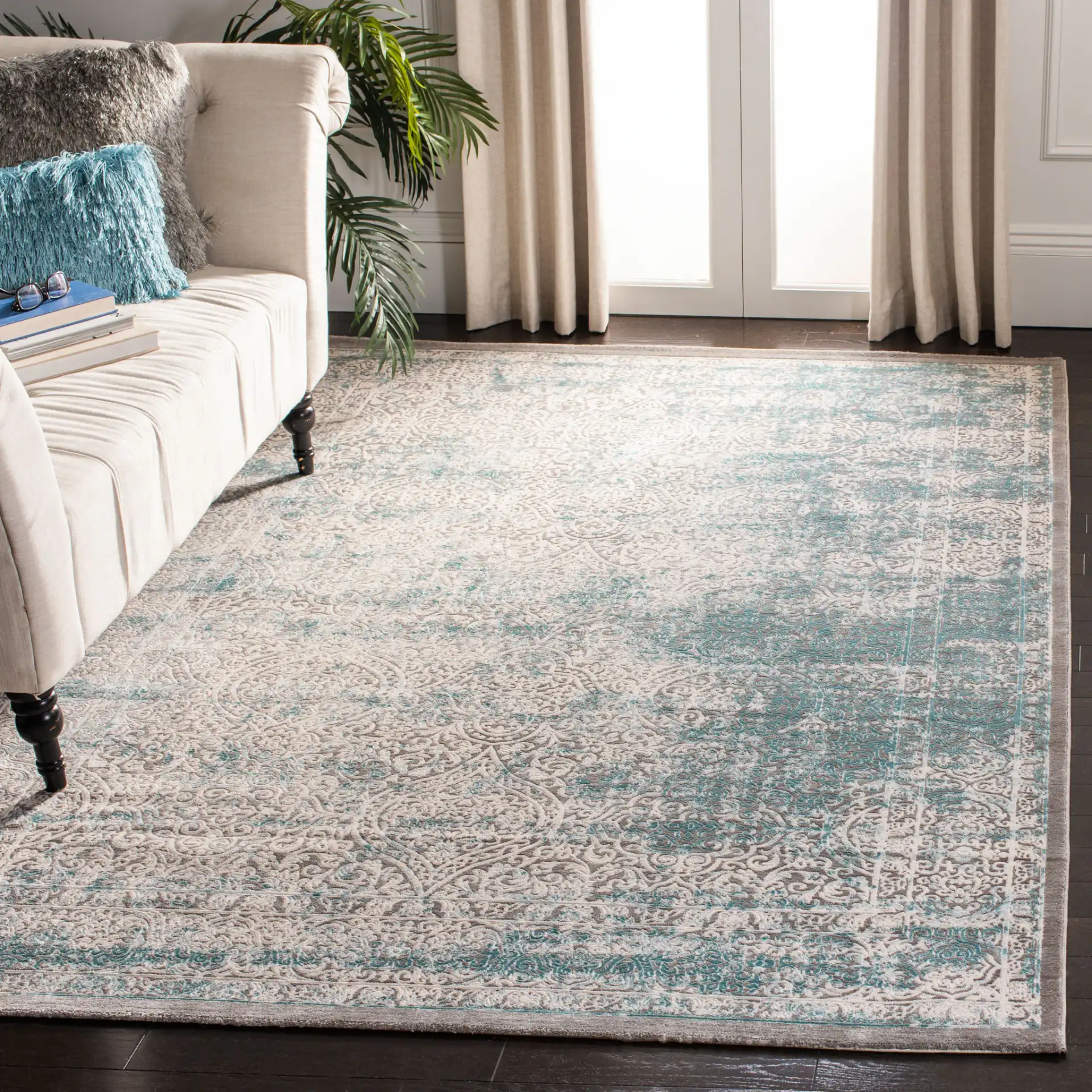 Passion Distressed Floral Bordered Rug in Turquoise / Ivory in a styled room