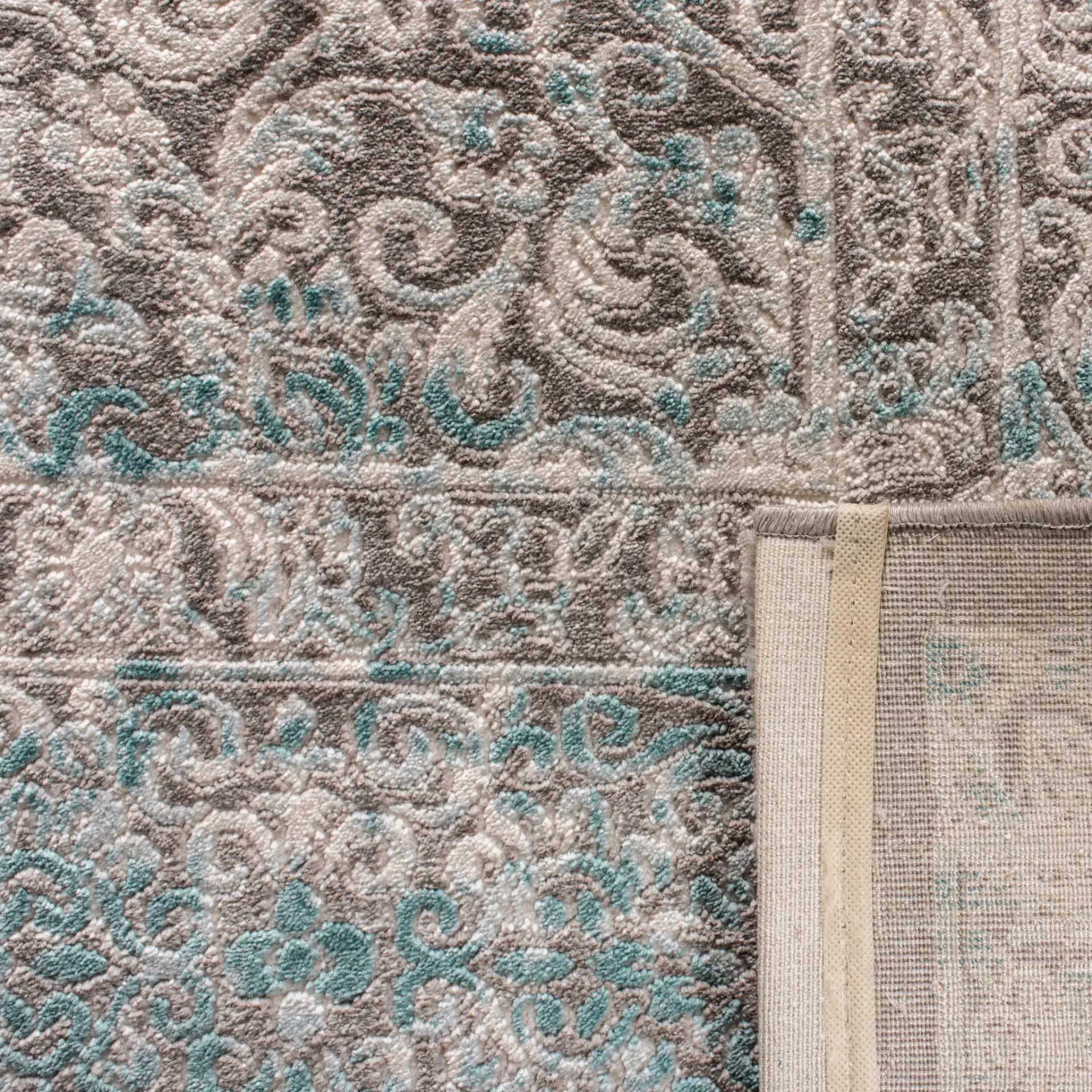 Passion Distressed Floral Bordered Rug in Turquoise / Ivory in a styled room