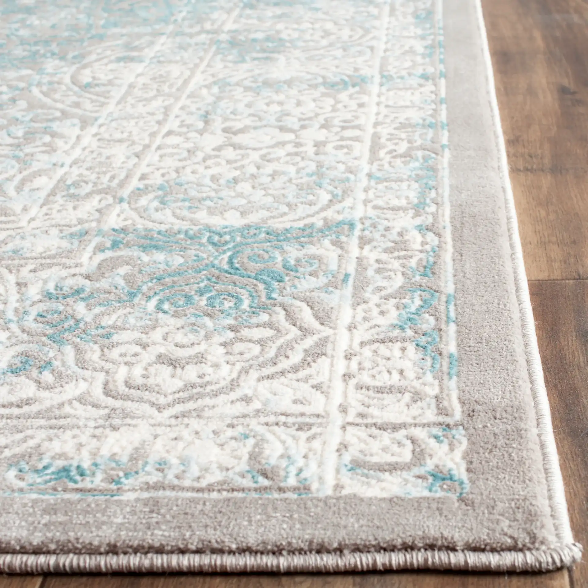 Passion Distressed Floral Bordered Rug in Turquoise / Ivory in a styled room