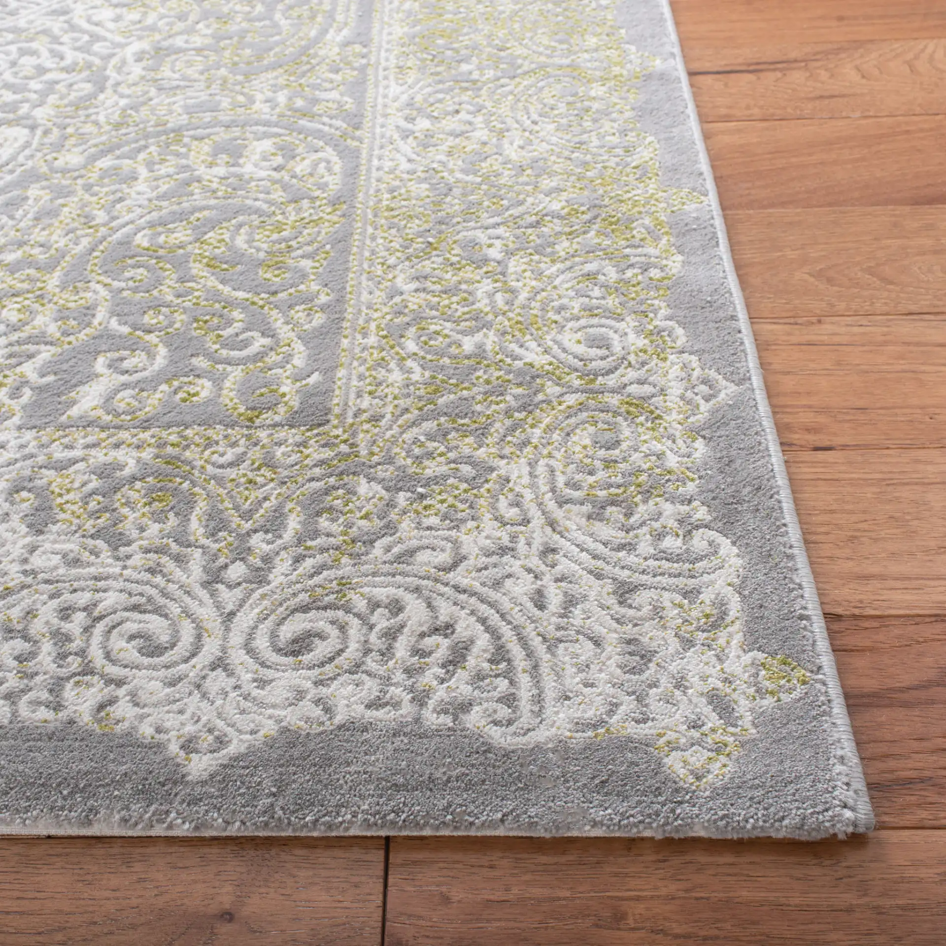 Passion Distressed Scroll Medallion Rug in Gray / Green in a styled room